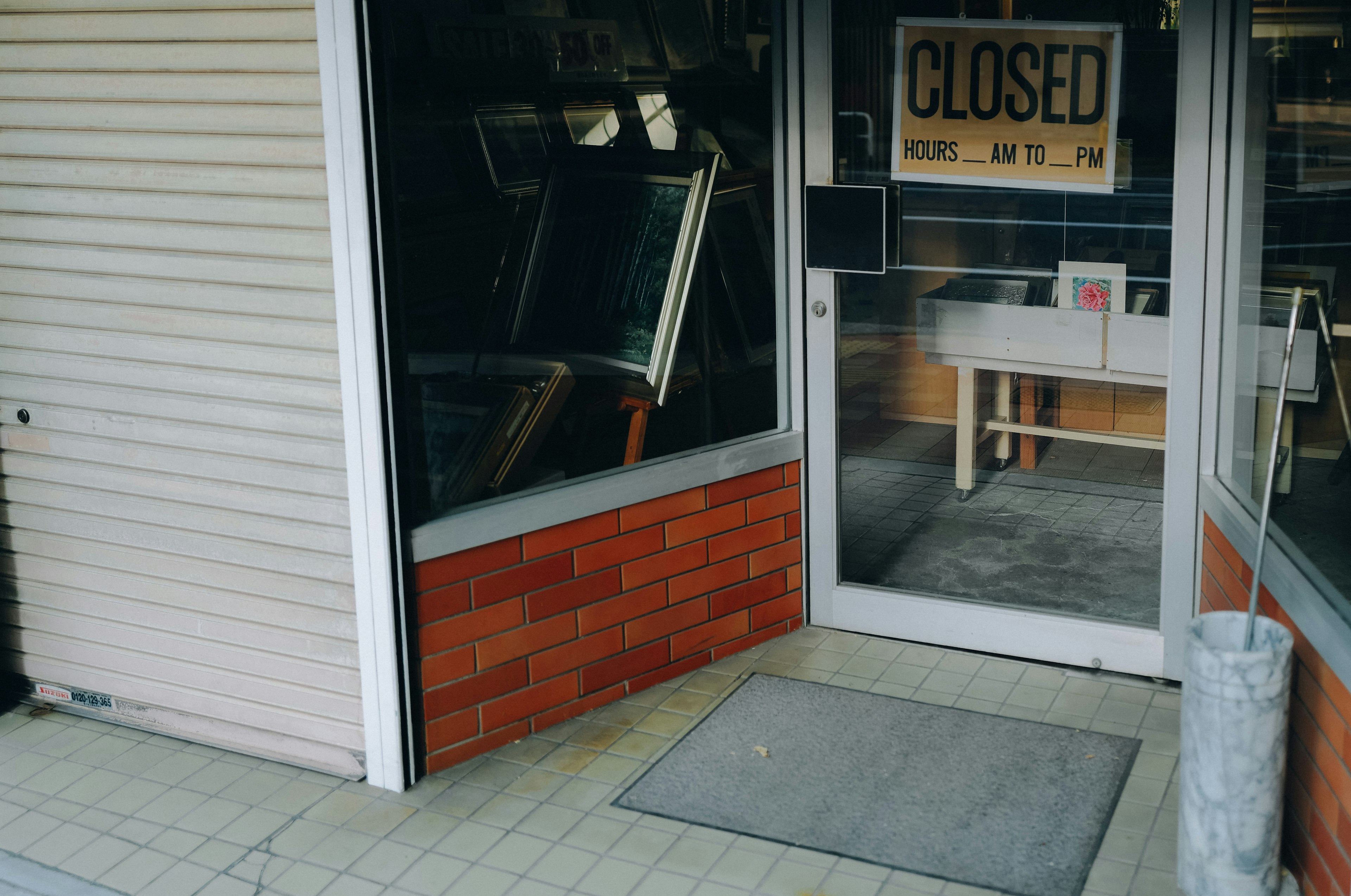 Entrance of a closed store with a visible sign