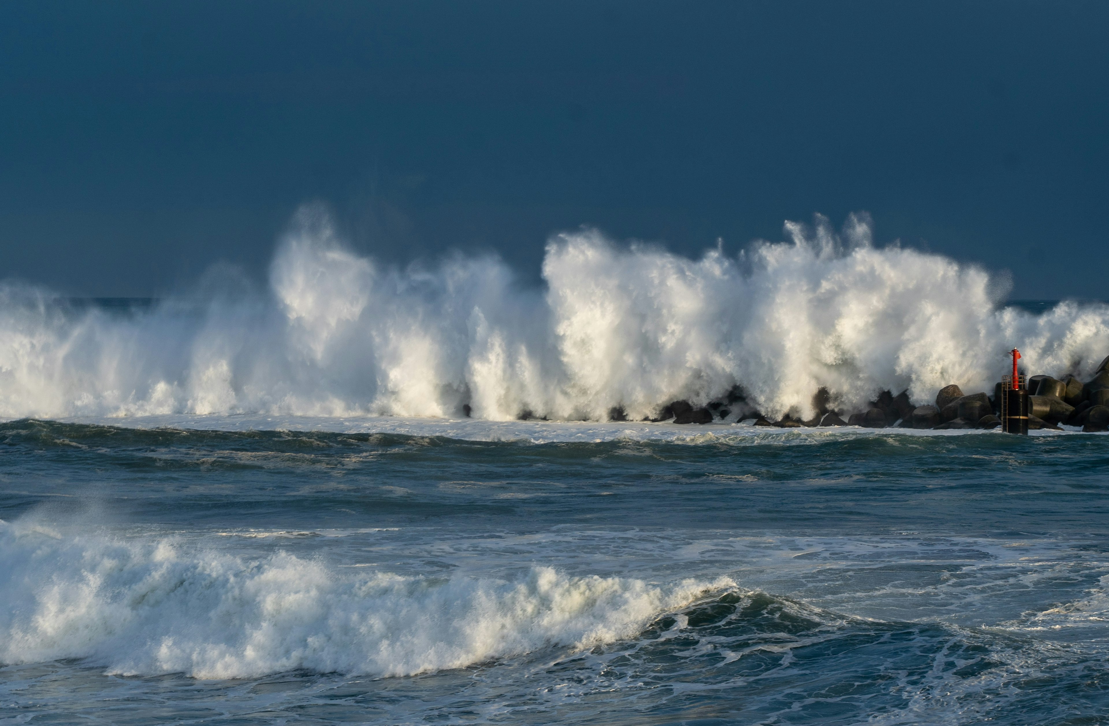 Crashing waves hitting rocks in a stormy sea