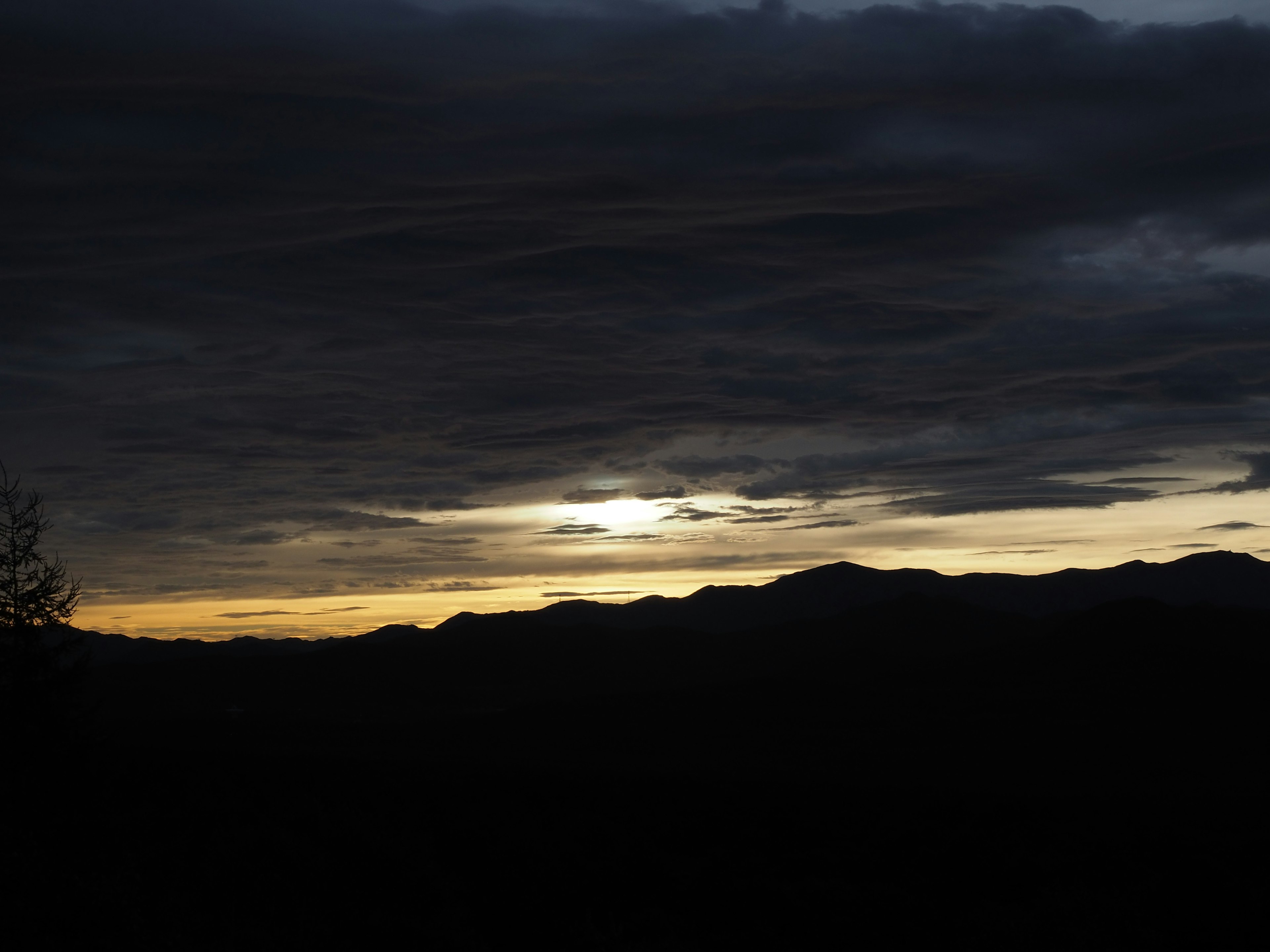 Dusk with mountains and a cloudy sky