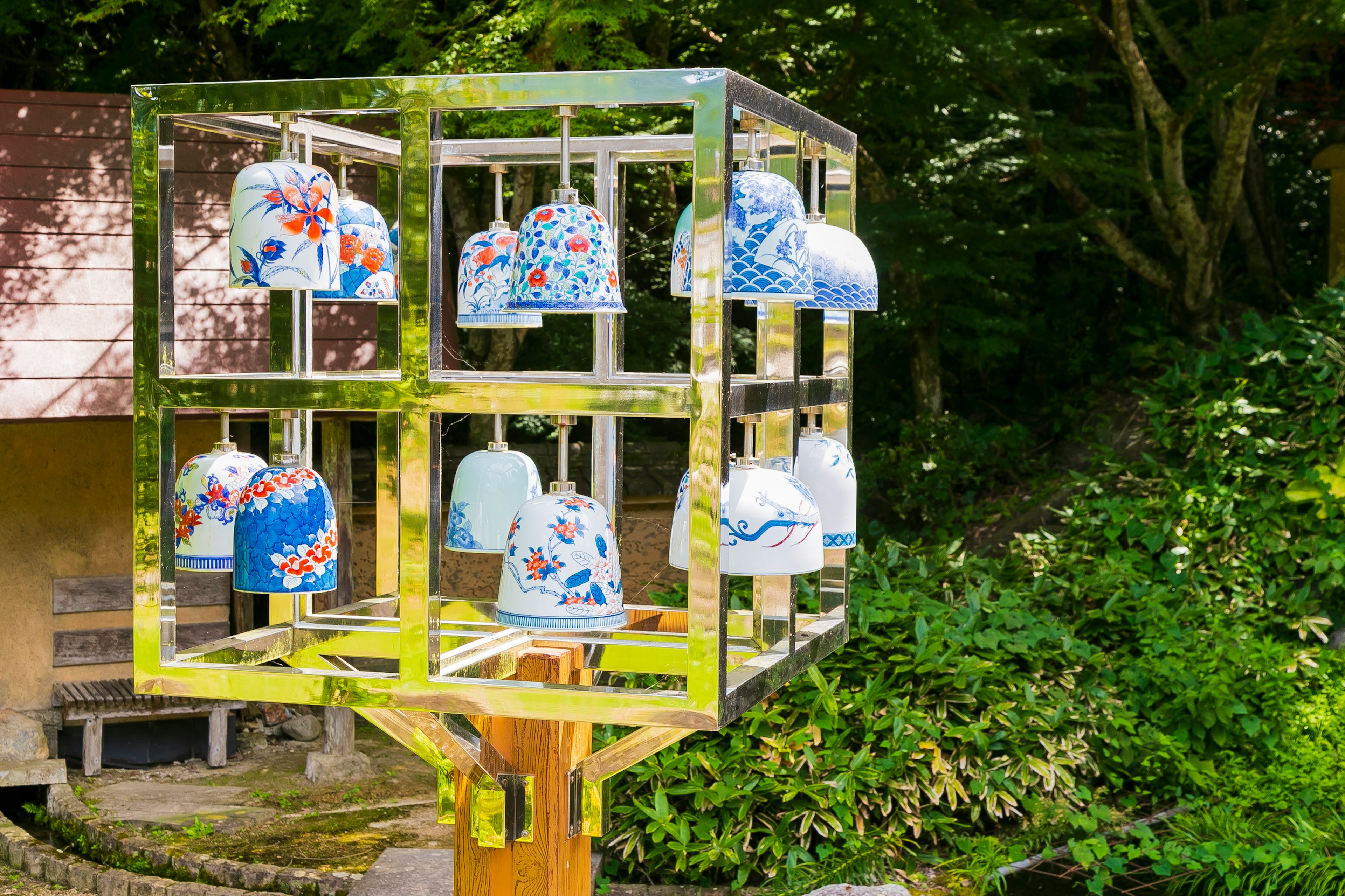 Colorful ceramic bells arranged in a metallic cube art structure