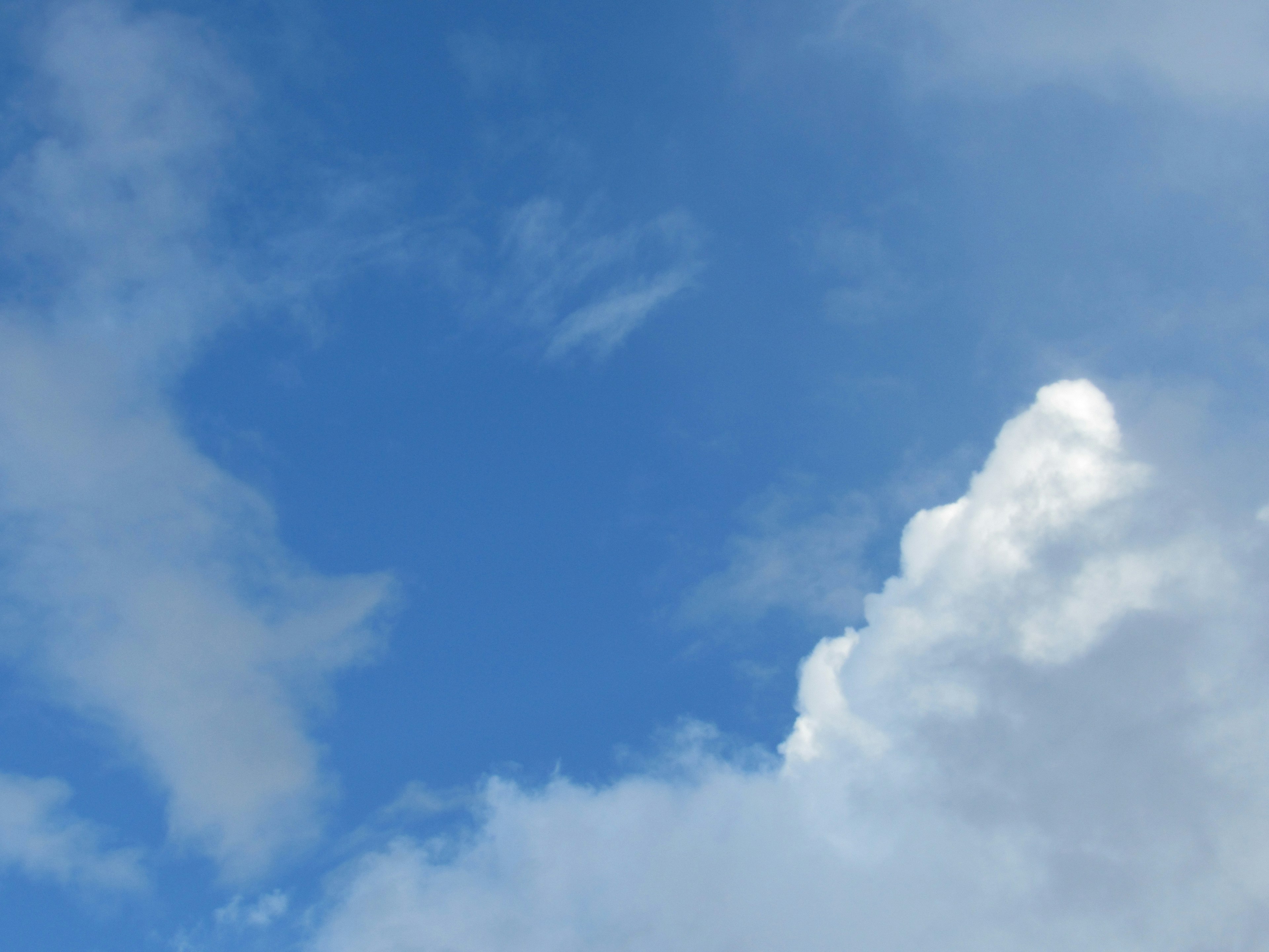 Bright blue sky with fluffy white clouds