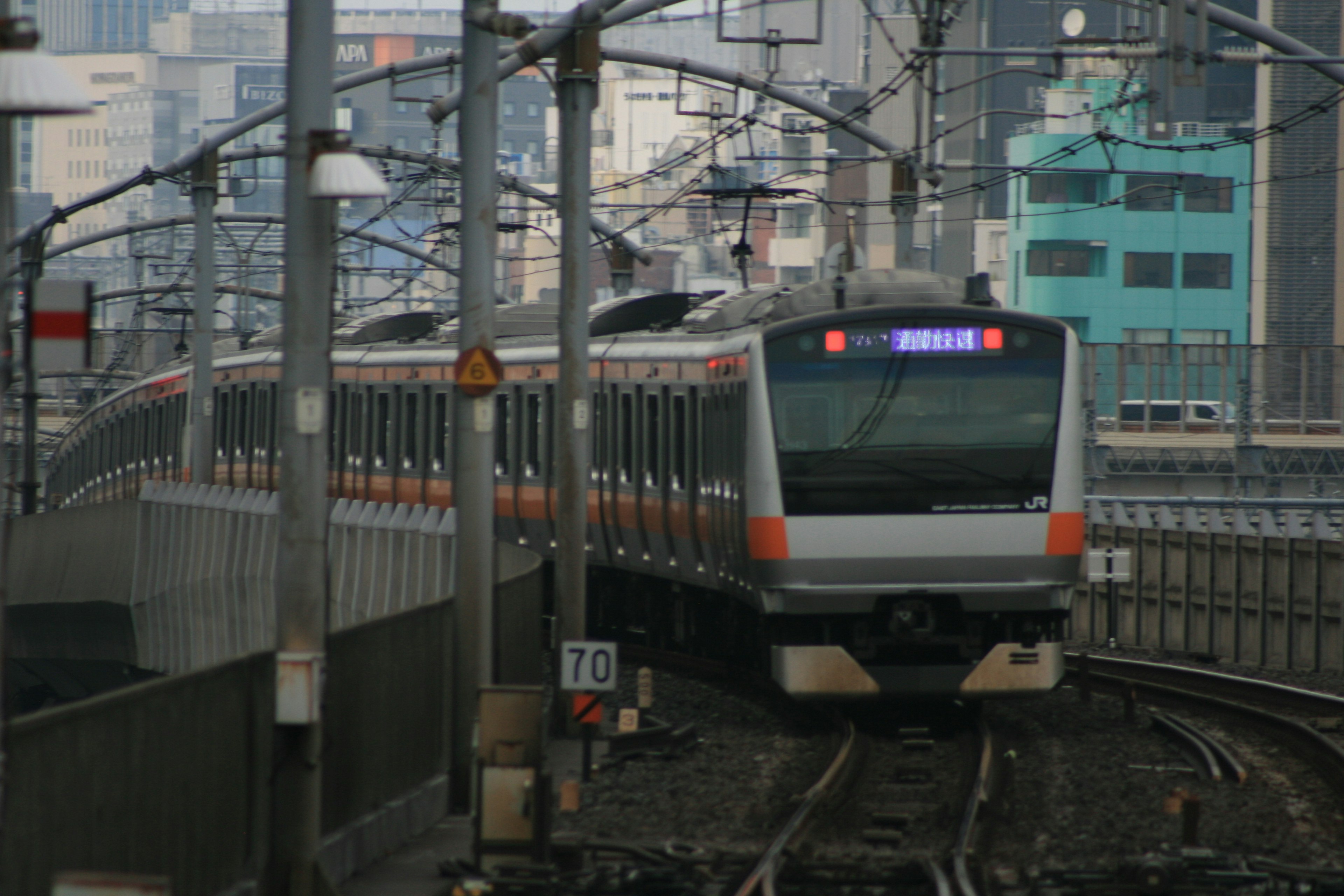 Foreground of a train on urban railway with buildings in the background