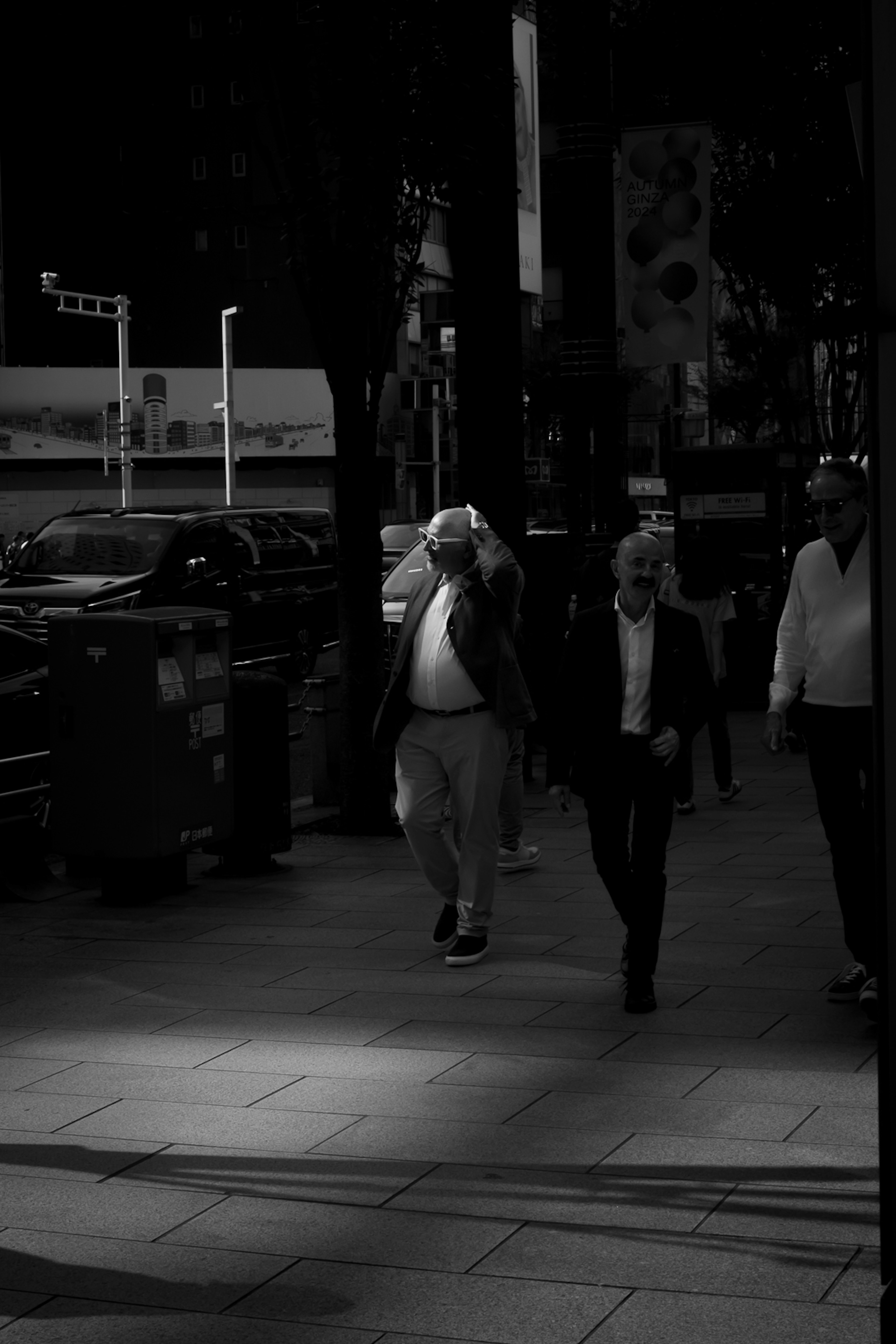 Businessmen walking on a monochrome city street