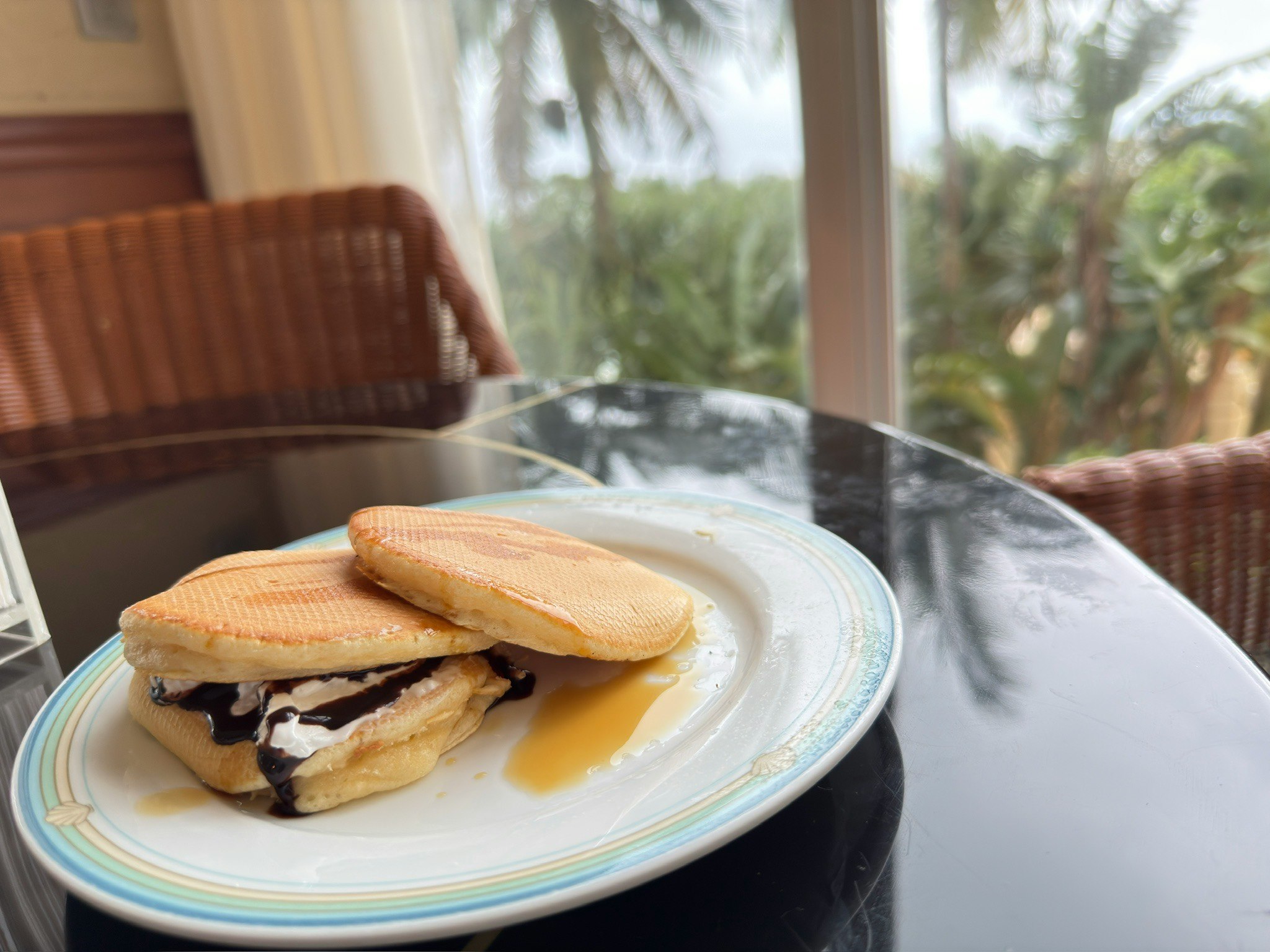 Delicious dessert on a plate with a view of lush greenery in the background