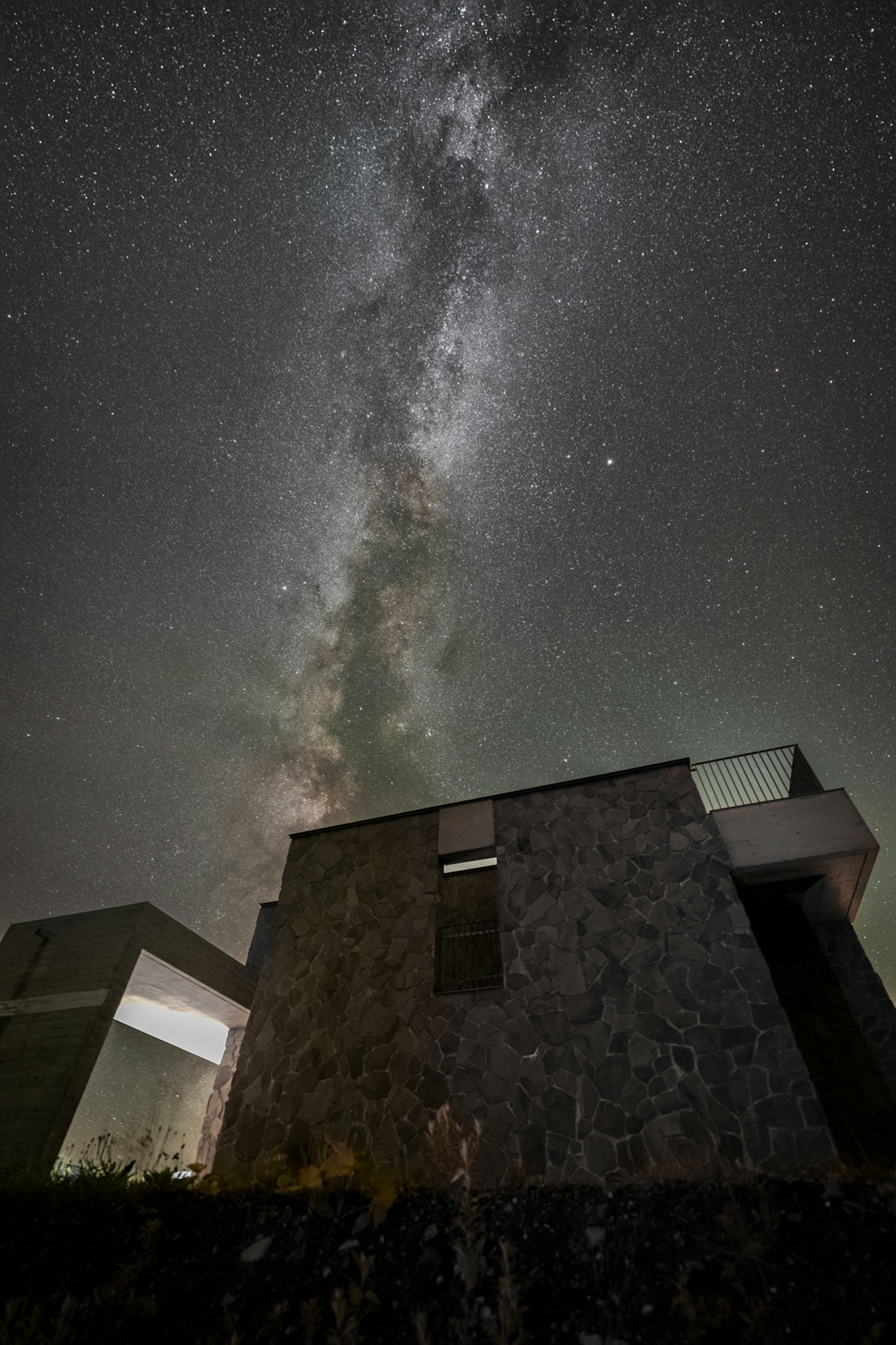 Modern building under a starry sky with the Milky Way