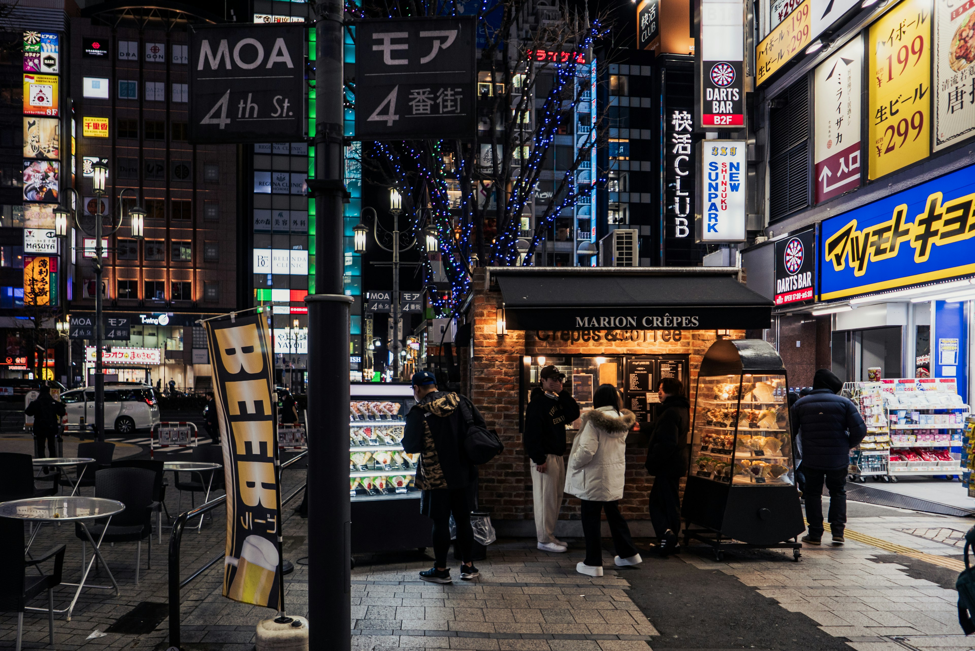 Exterior de un café en Kabukicho de noche con personas