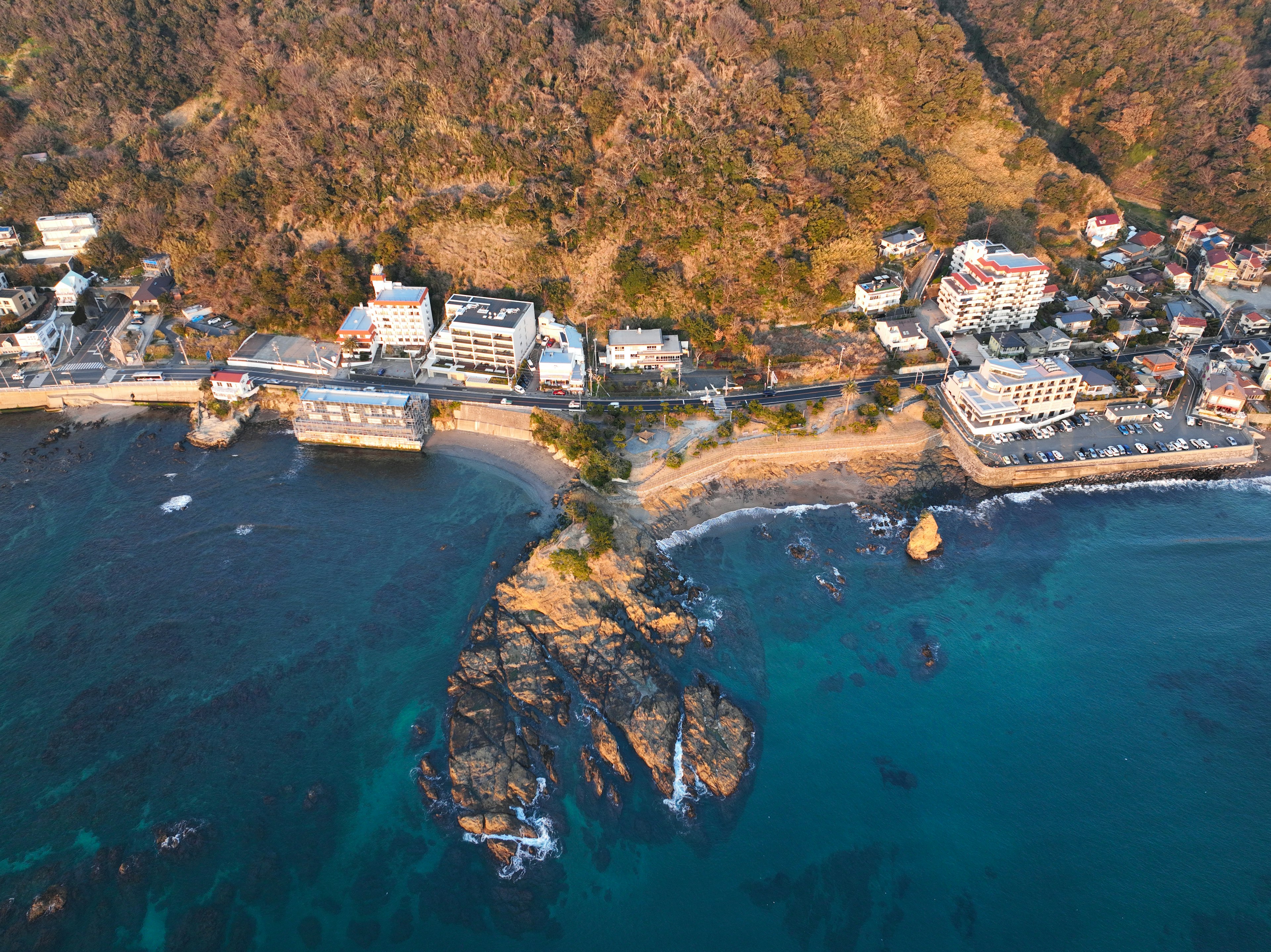 Aerial view of a coastal landscape with rocks and buildings