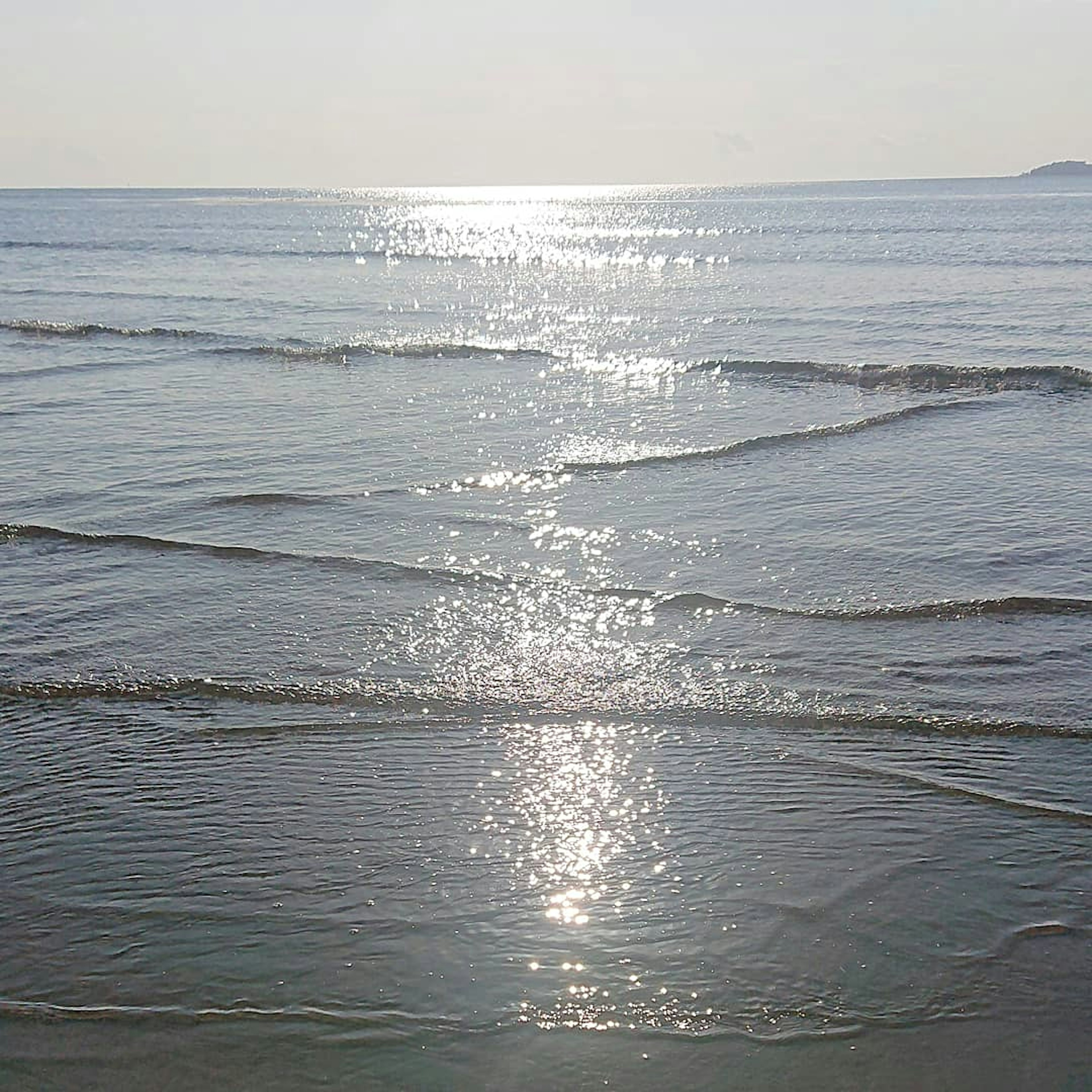 Calm sea view with reflections on the waves