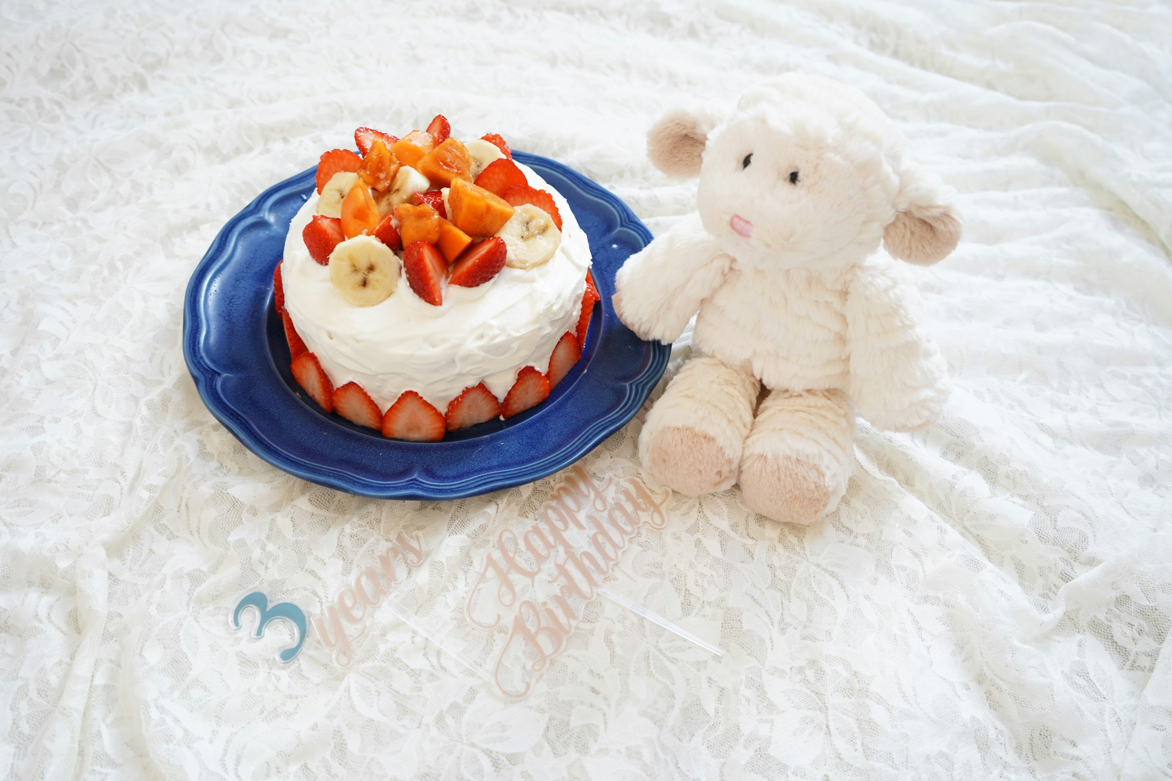 A cute arrangement of a cake and a plush toy