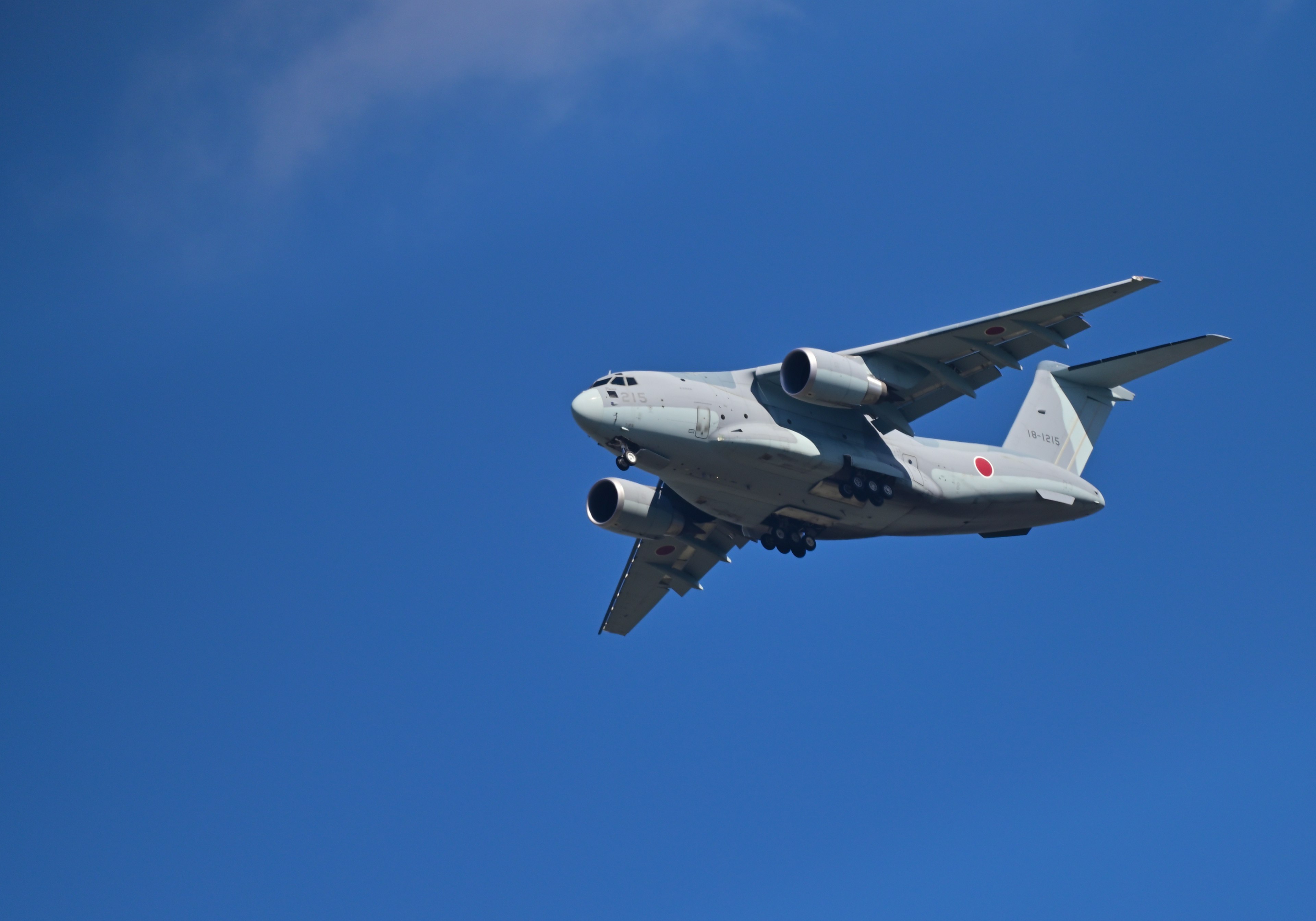 An aircraft flying against a clear blue sky