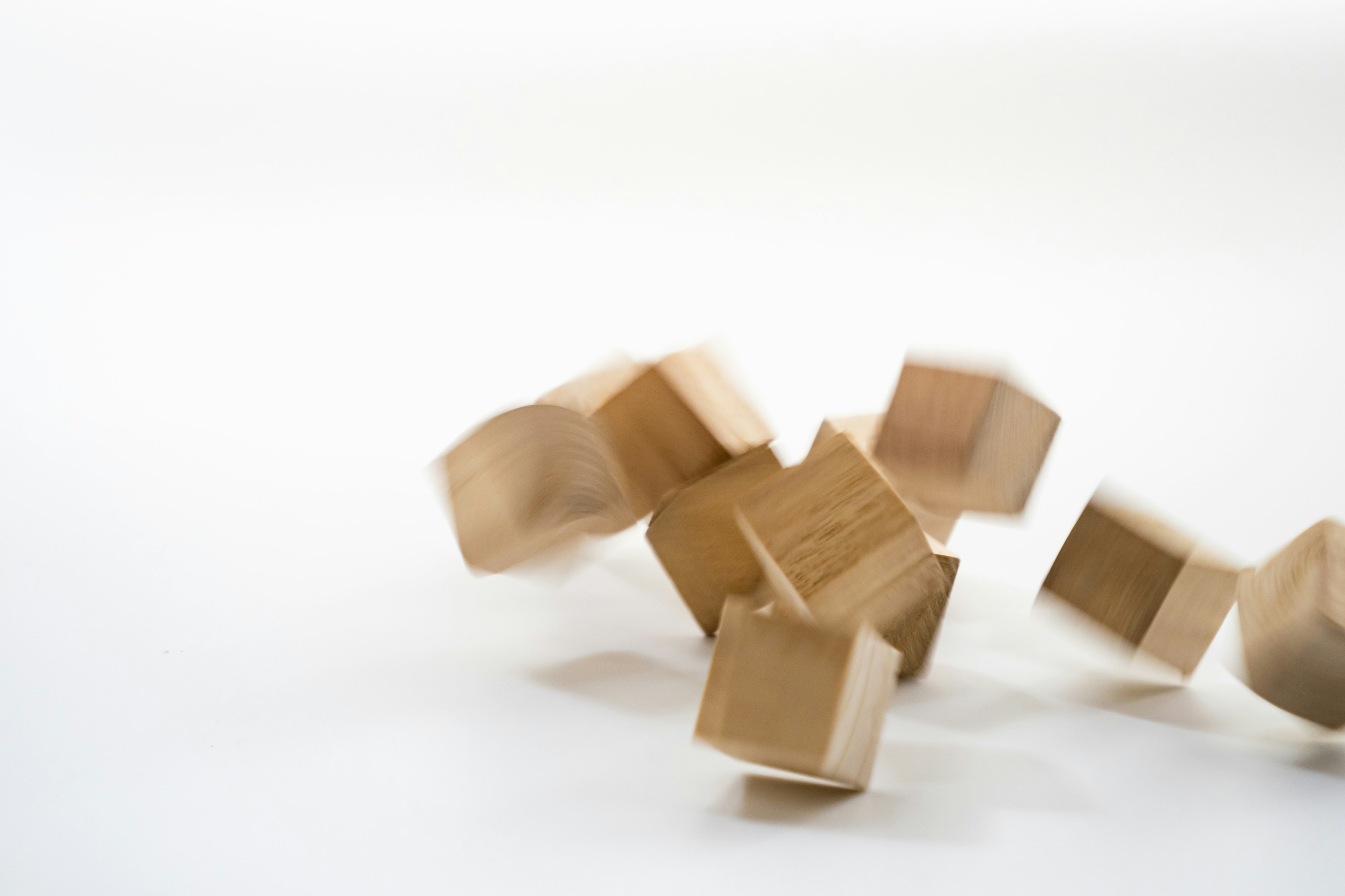 Wooden cubes rolling on a white background