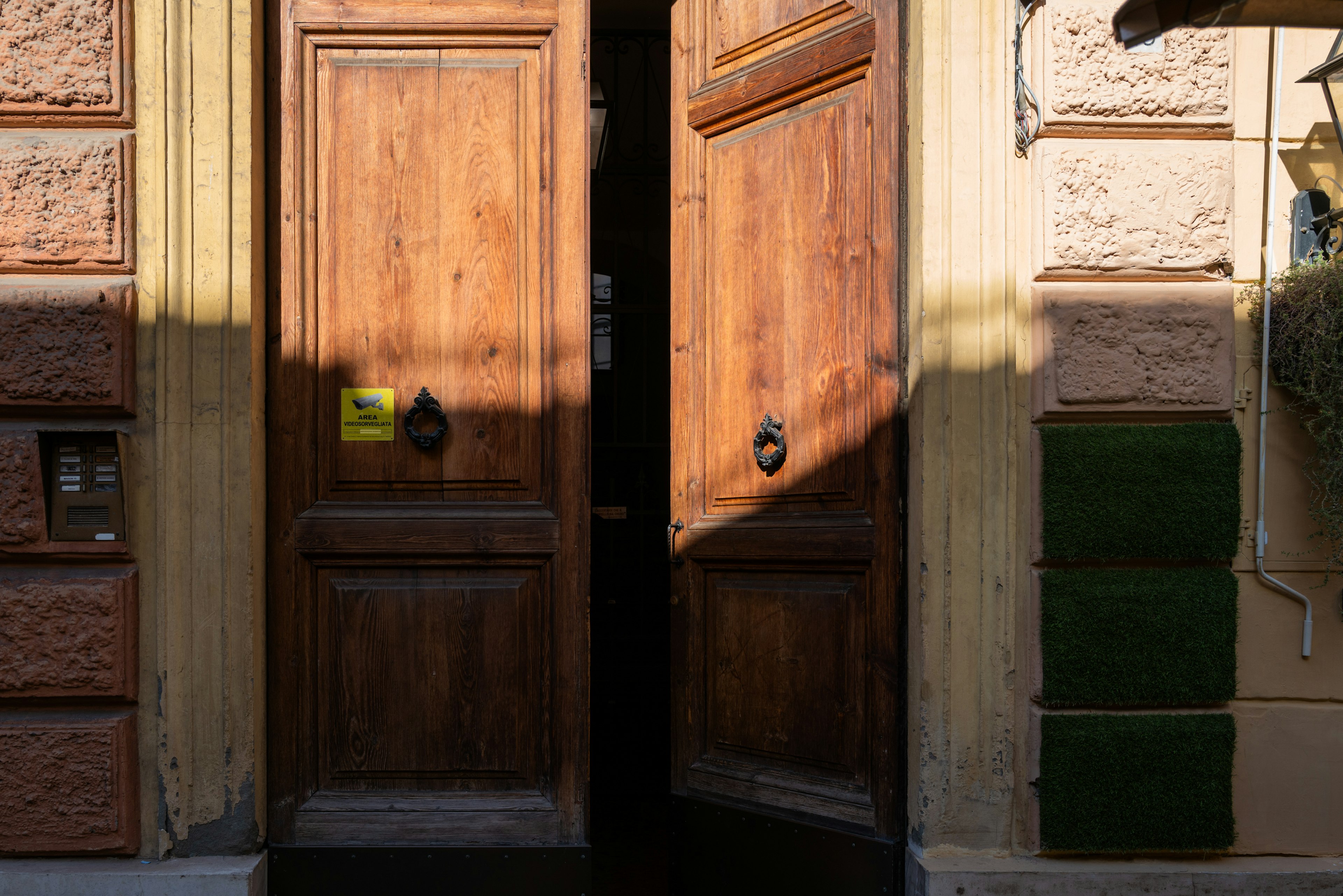 Porta in legno aperta di un vecchio edificio con parete testurizzata