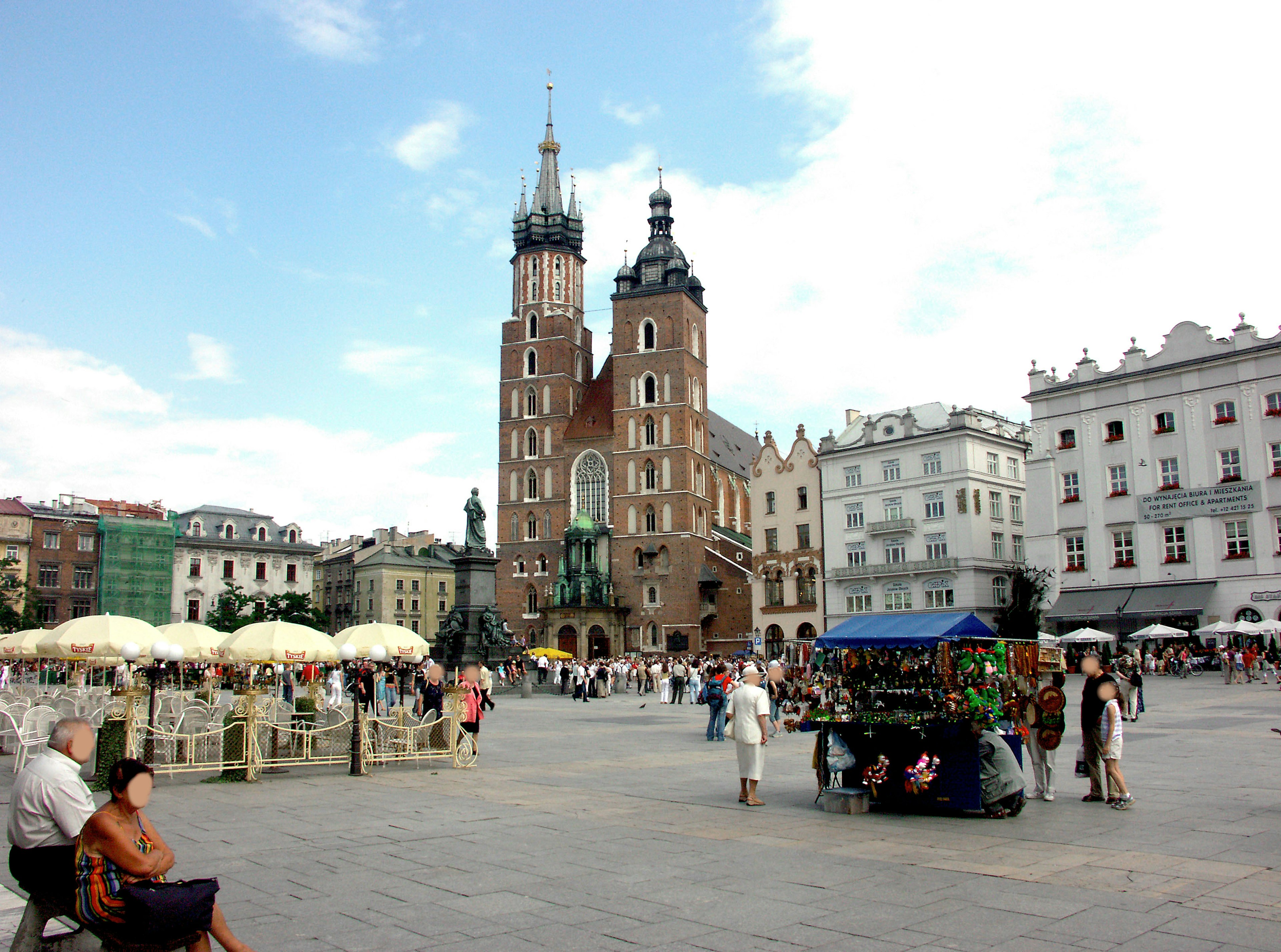 Vibrant scene of Krakow's Main Square featuring St Mary's Basilica and market stalls