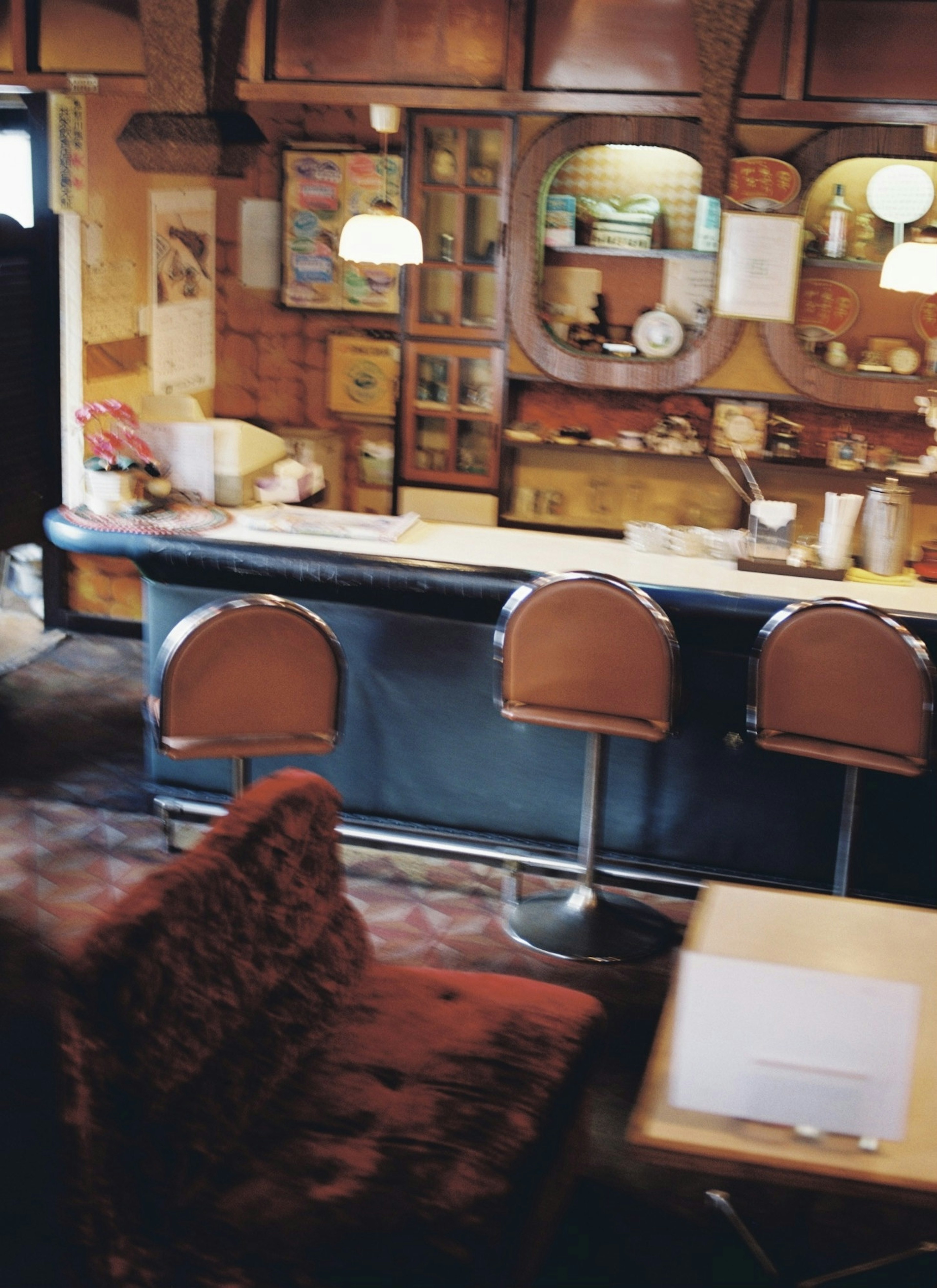 Interior of a retro cafe featuring a bar and seating area