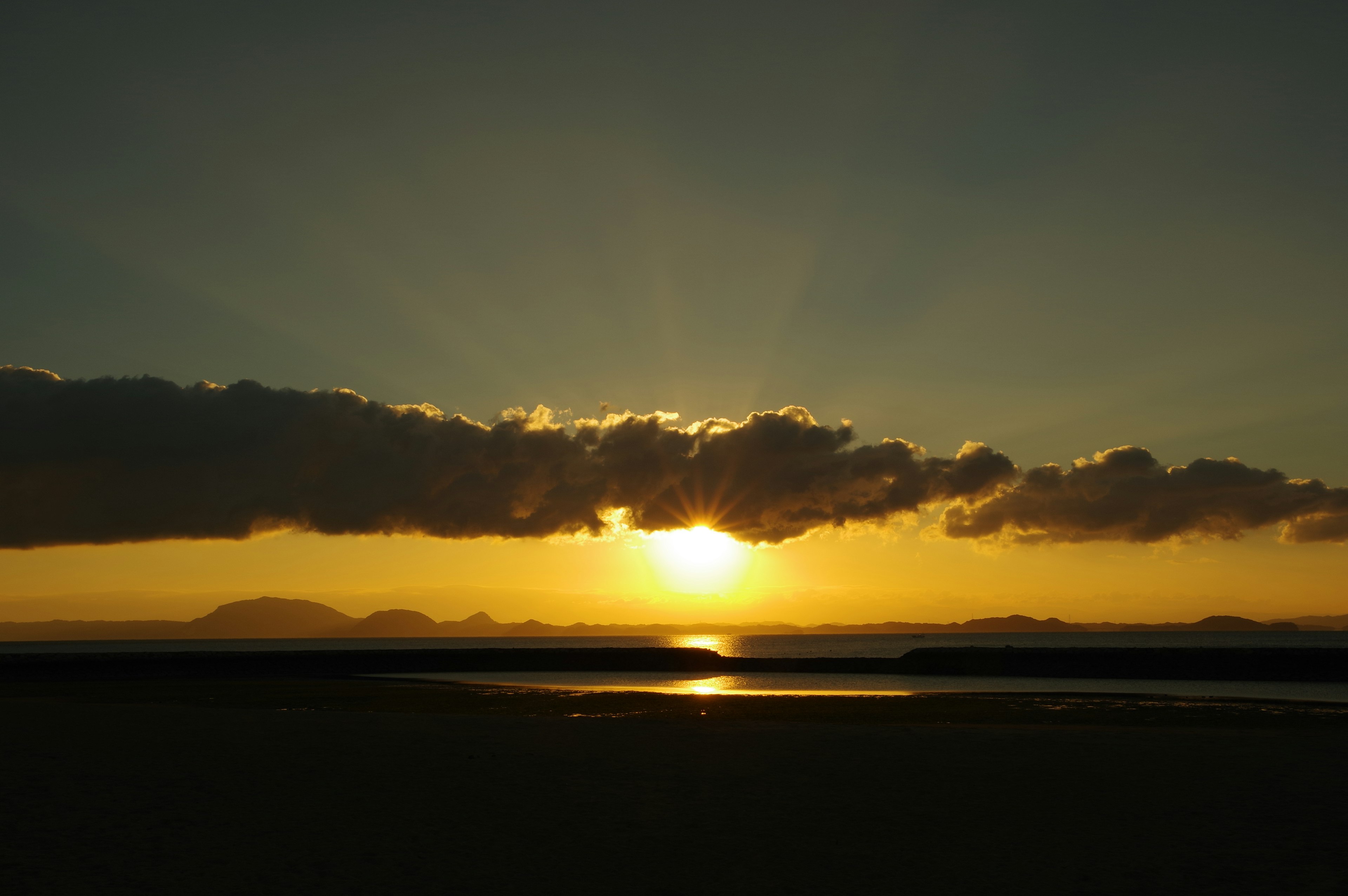 Beautiful sunset with rays shining through clouds