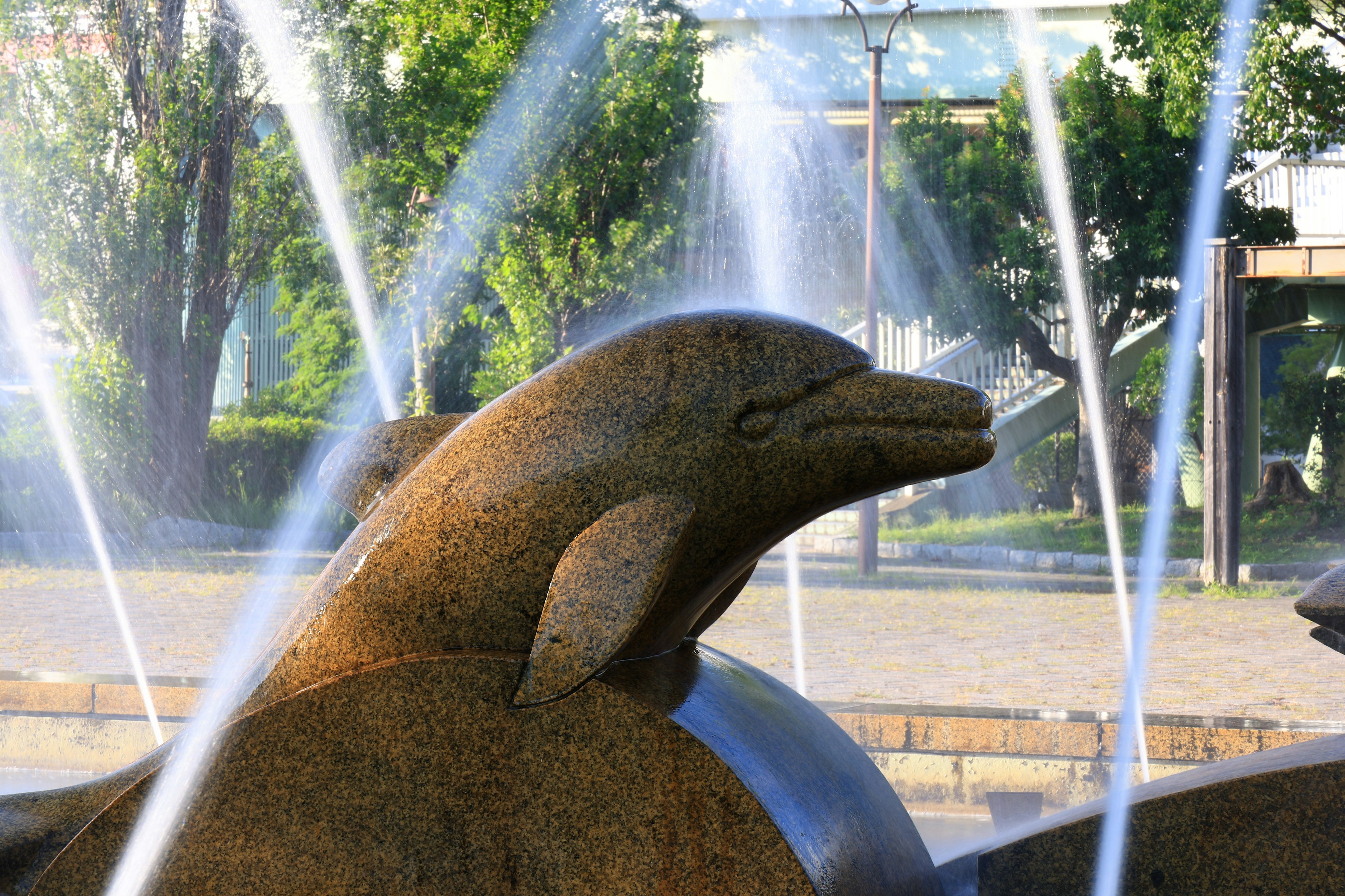 Sculpture of a dolphin fountain with water jets