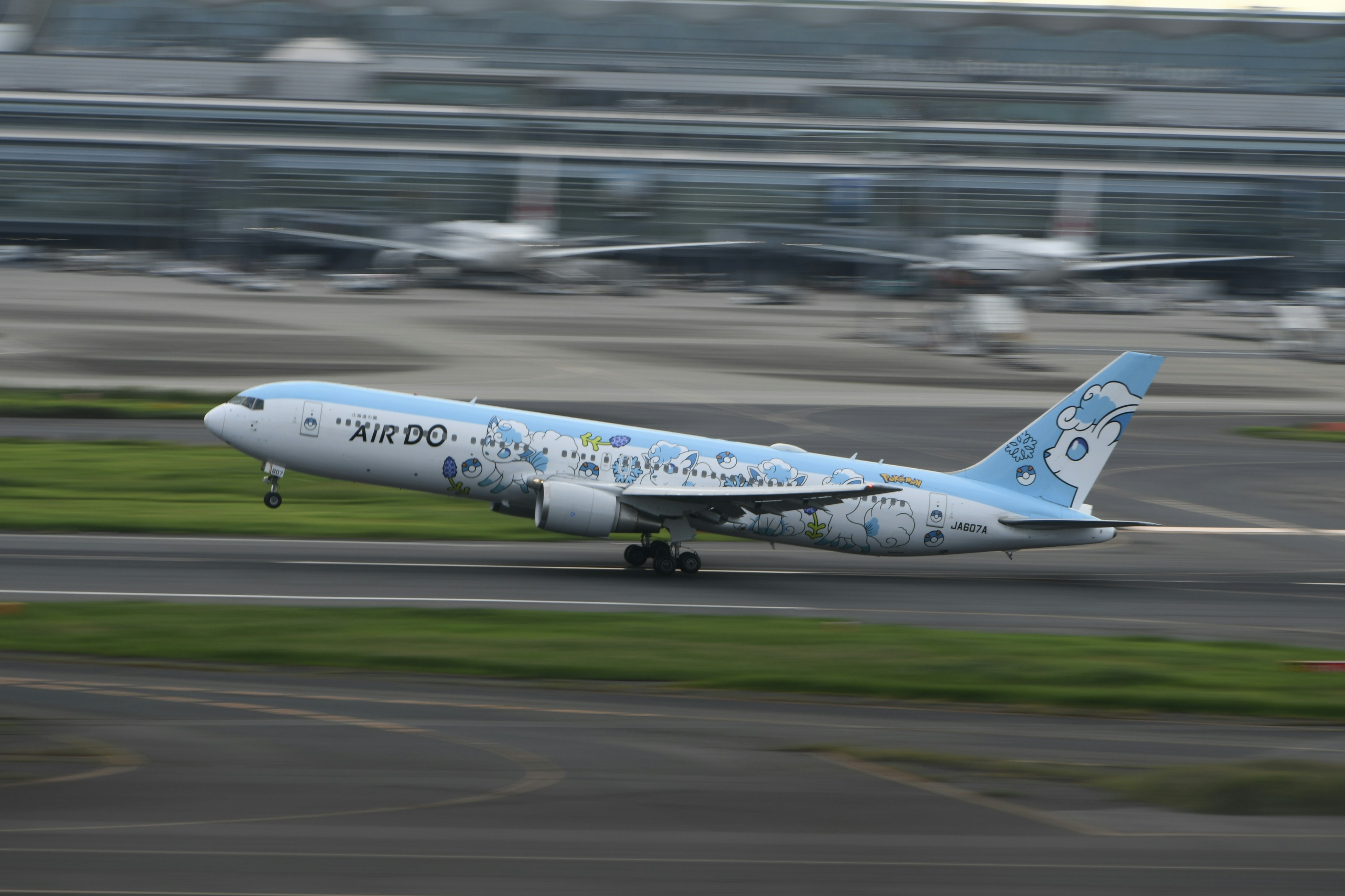 A blue-patterned airplane taking off from the runway