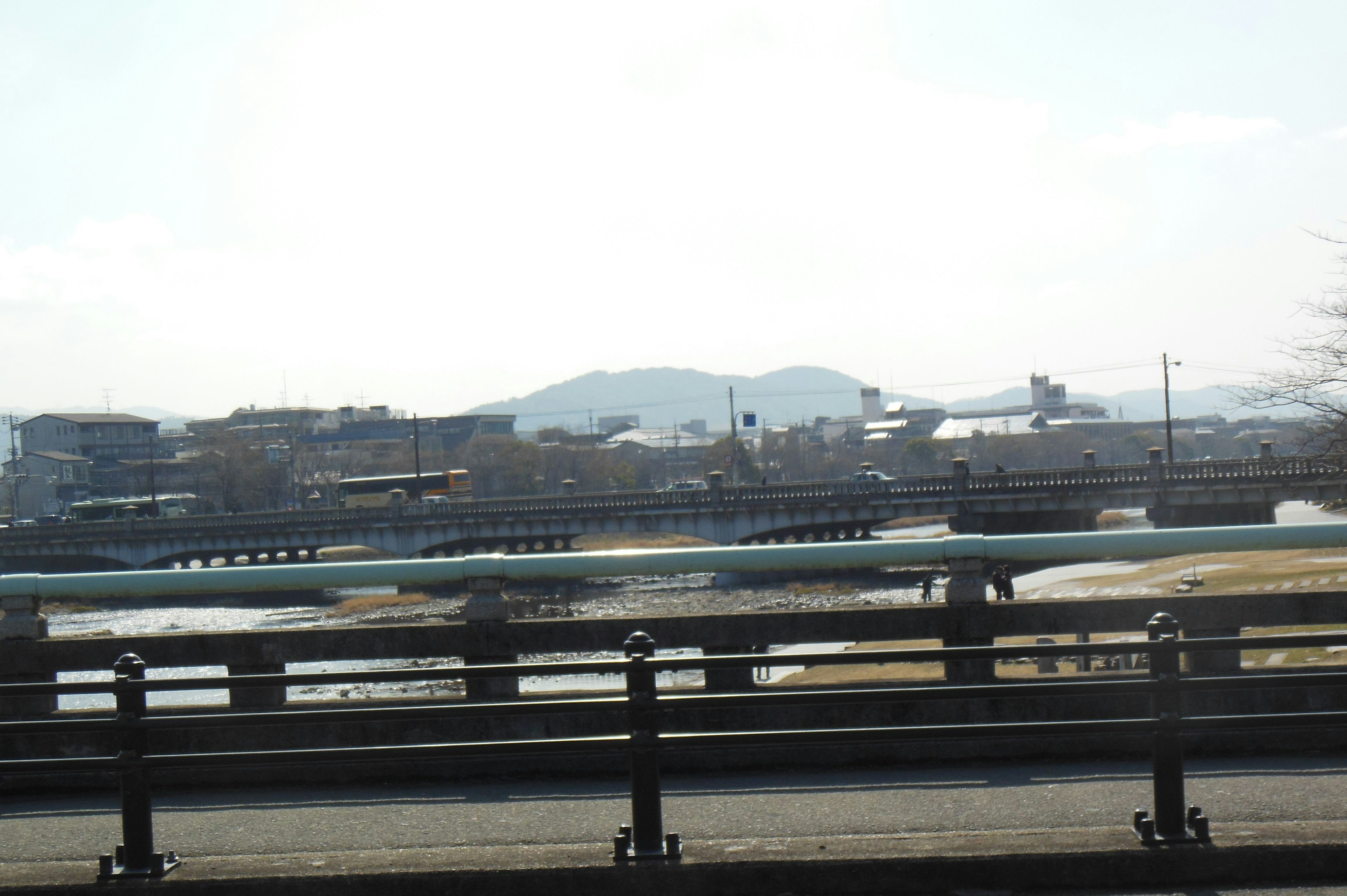 Photo of a road with a view of a river and mountains