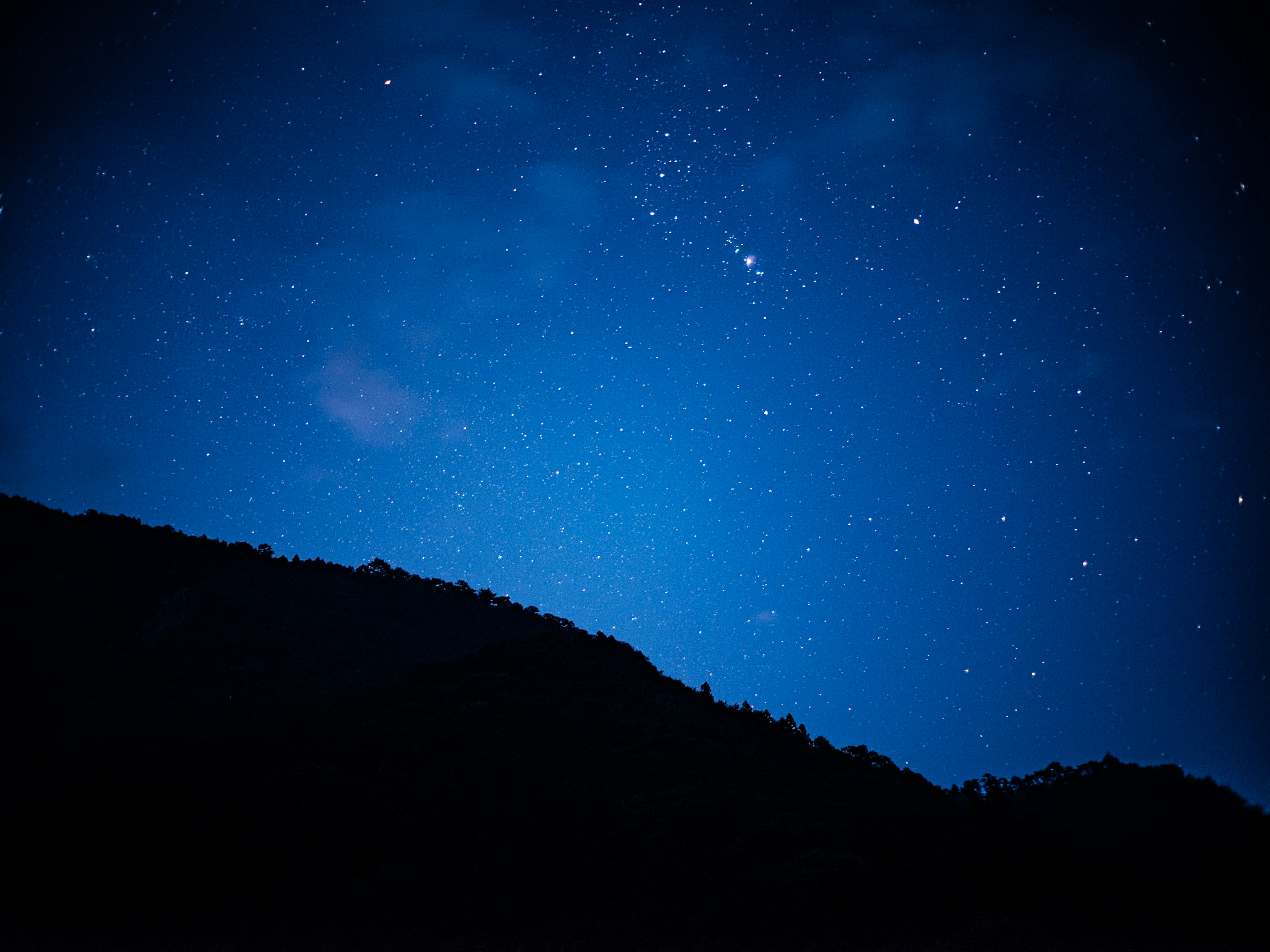 星空と山のシルエットが見える夜の風景