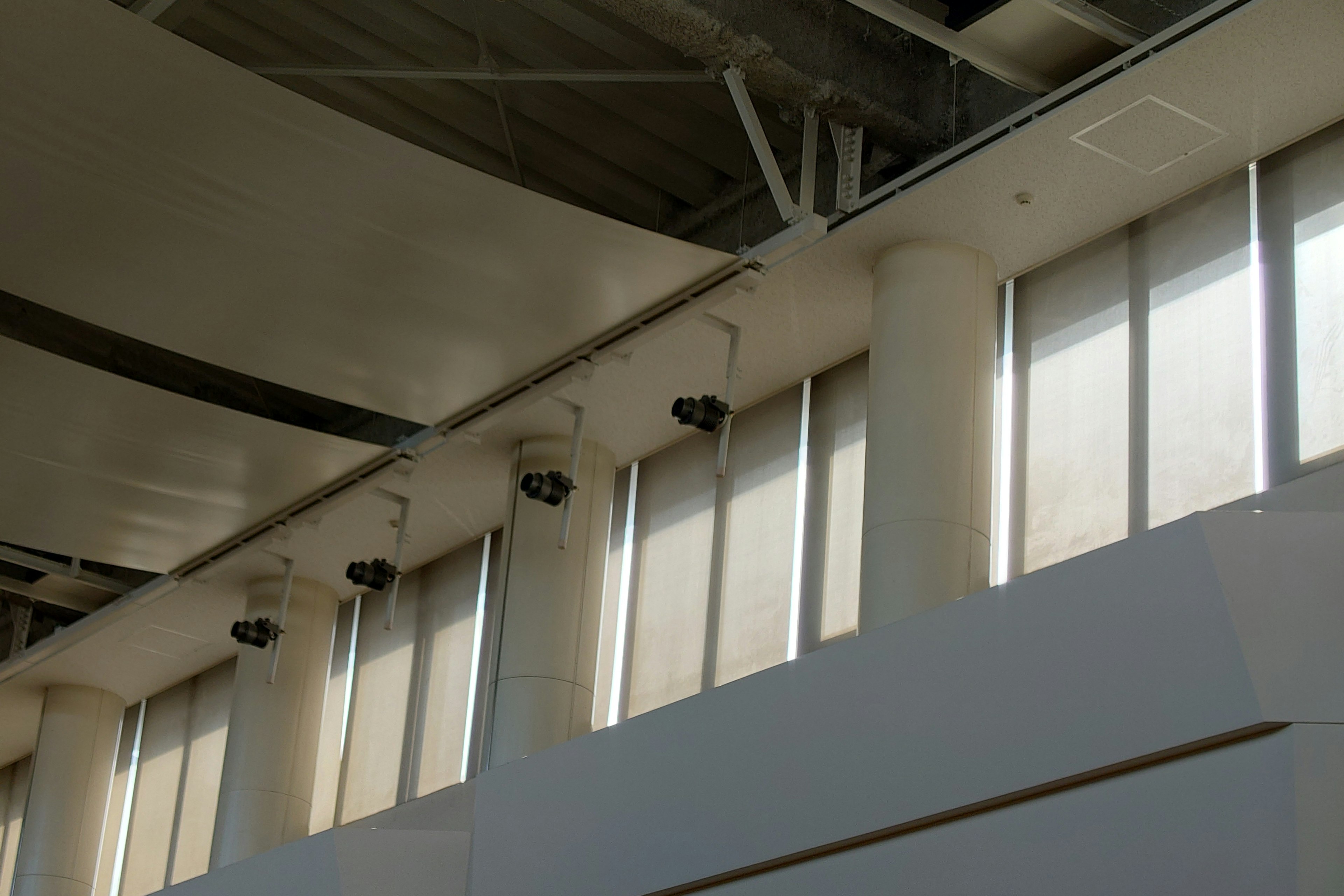 Interior of a modern building with white columns and large windows