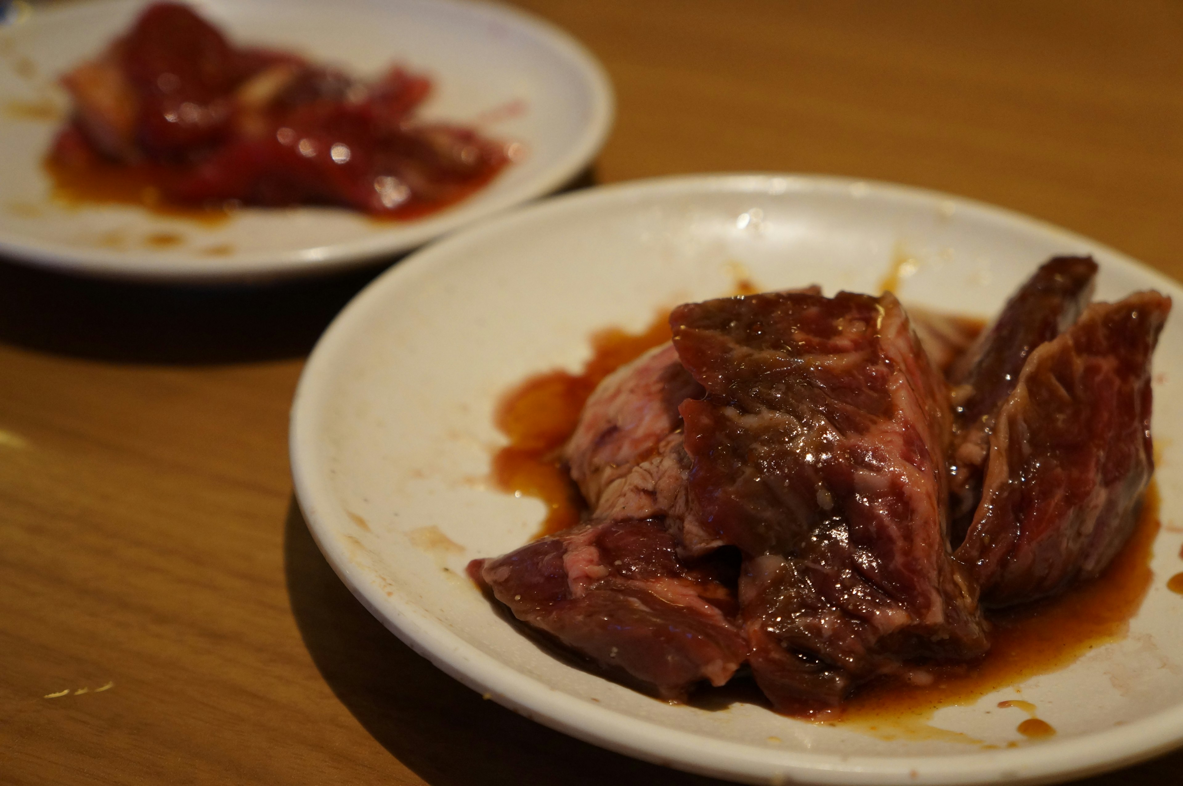 Sliced grilled meat on a plate with sauce