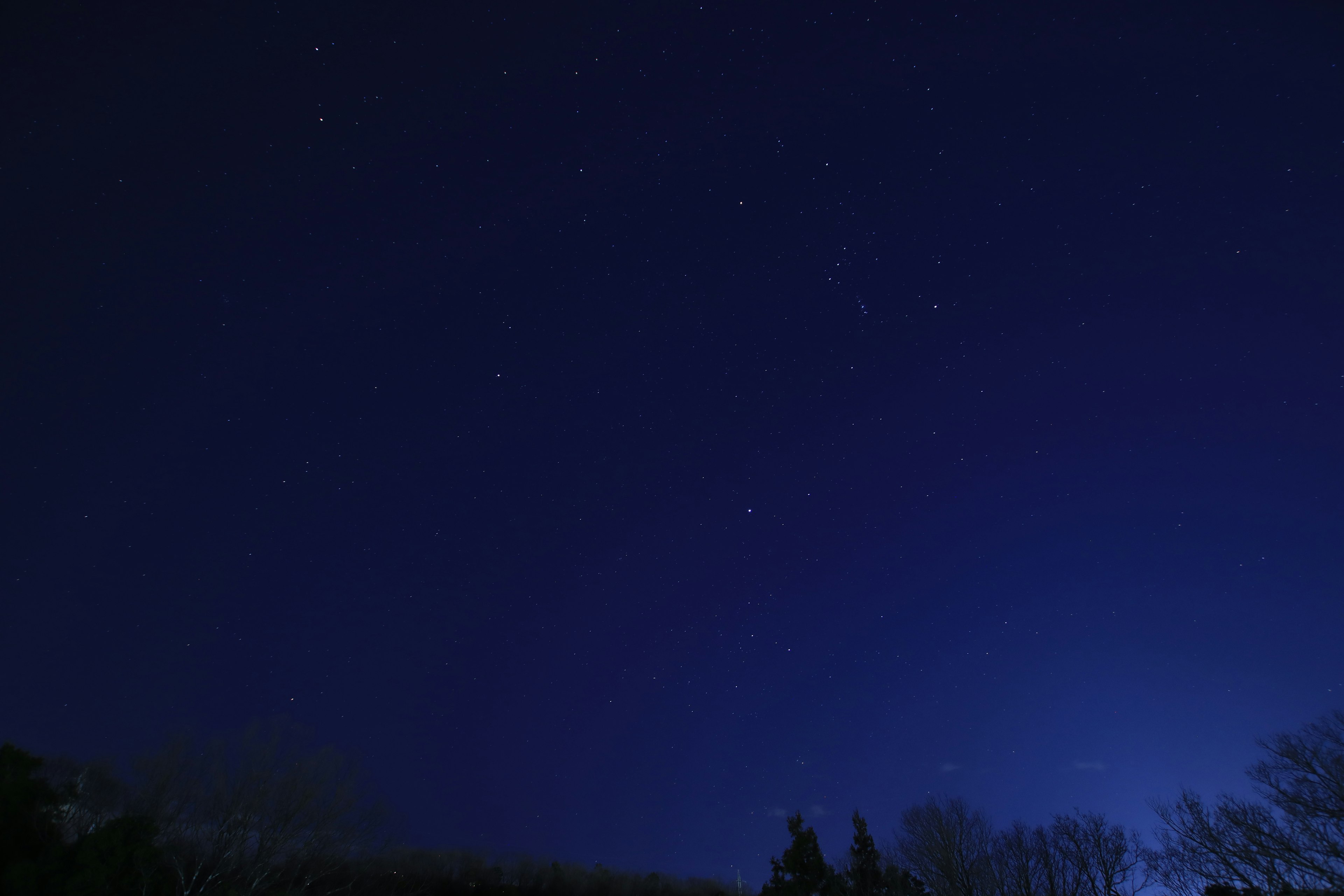 Starry night sky with deep blue background