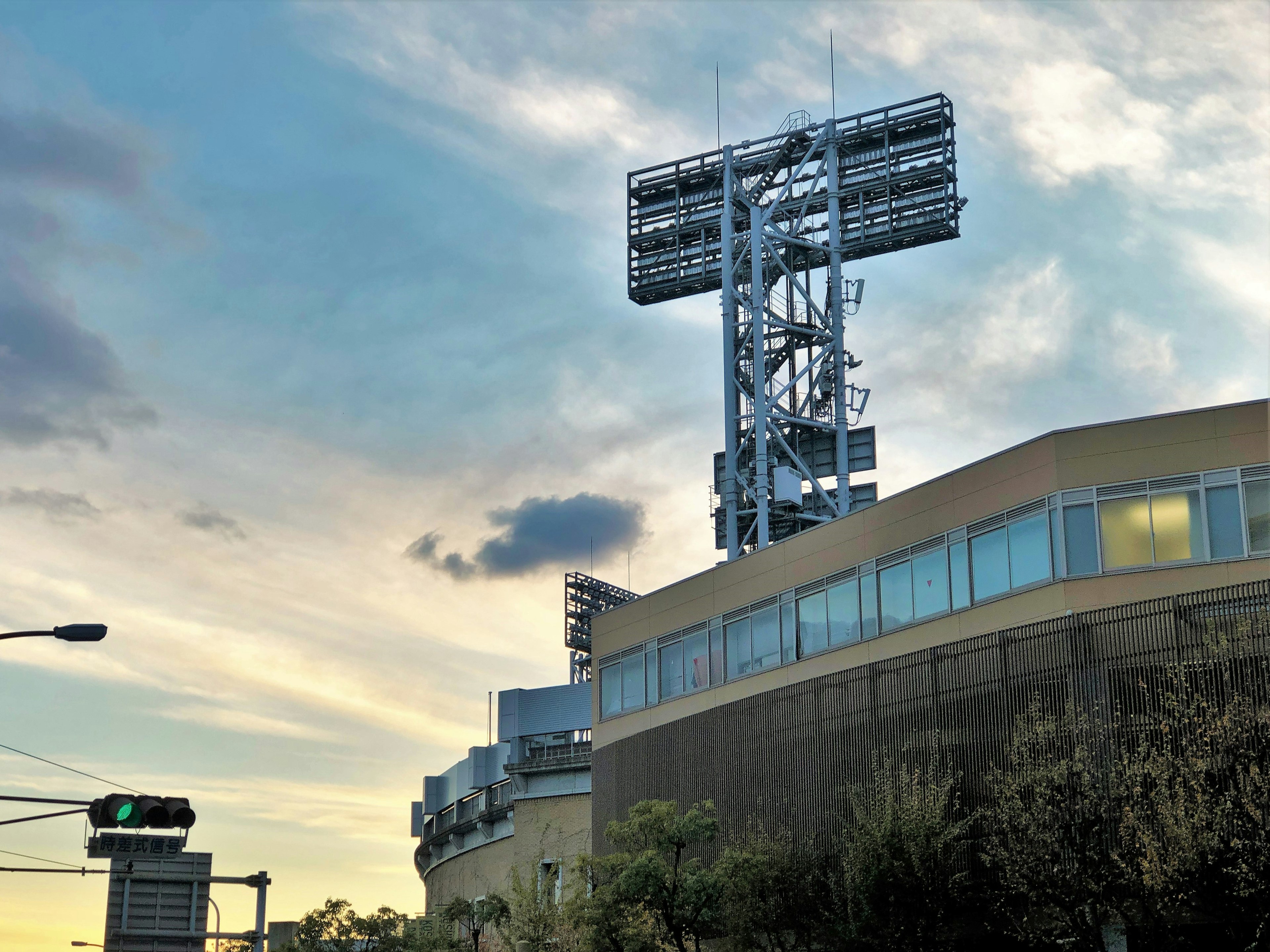 Large lighting tower on top of a building with a sunset sky