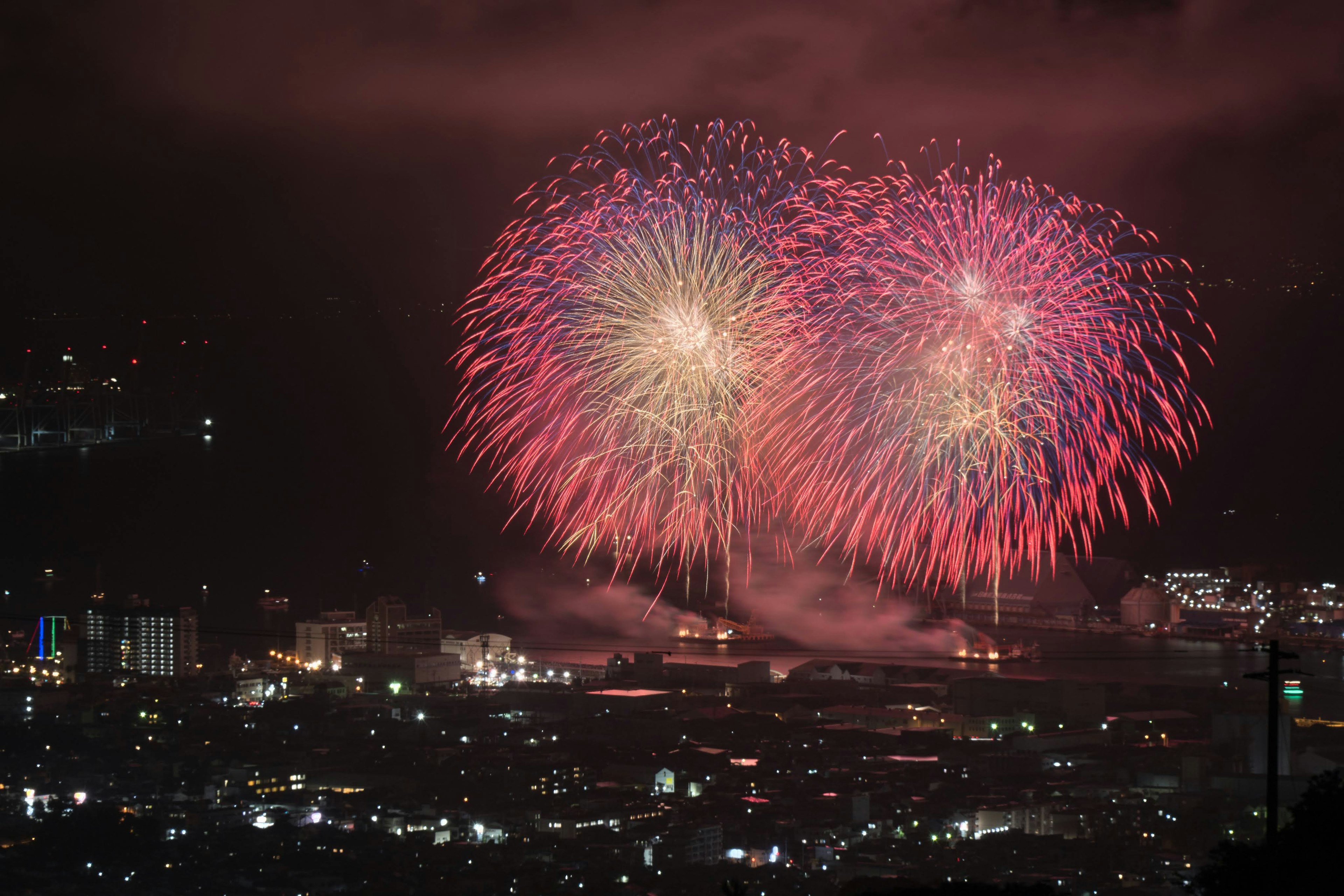 夜空中绽放的红色和白色烟花形成两个大圆的美丽景象