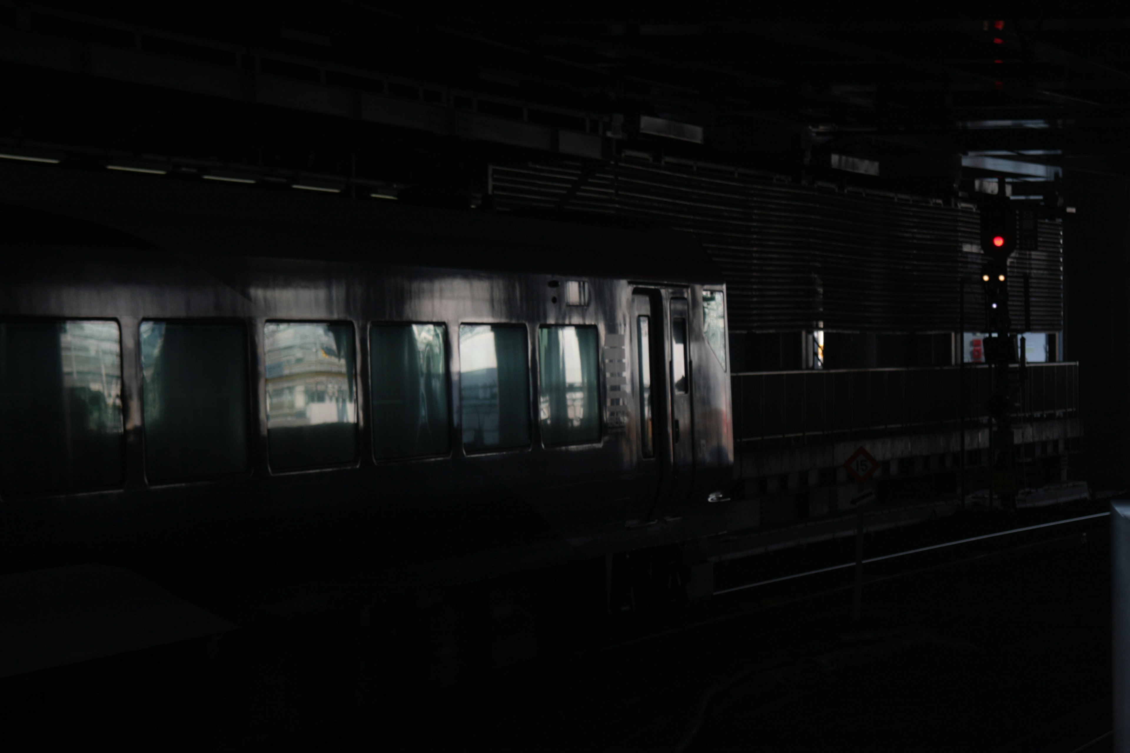 Side view of a train in a dark subway station