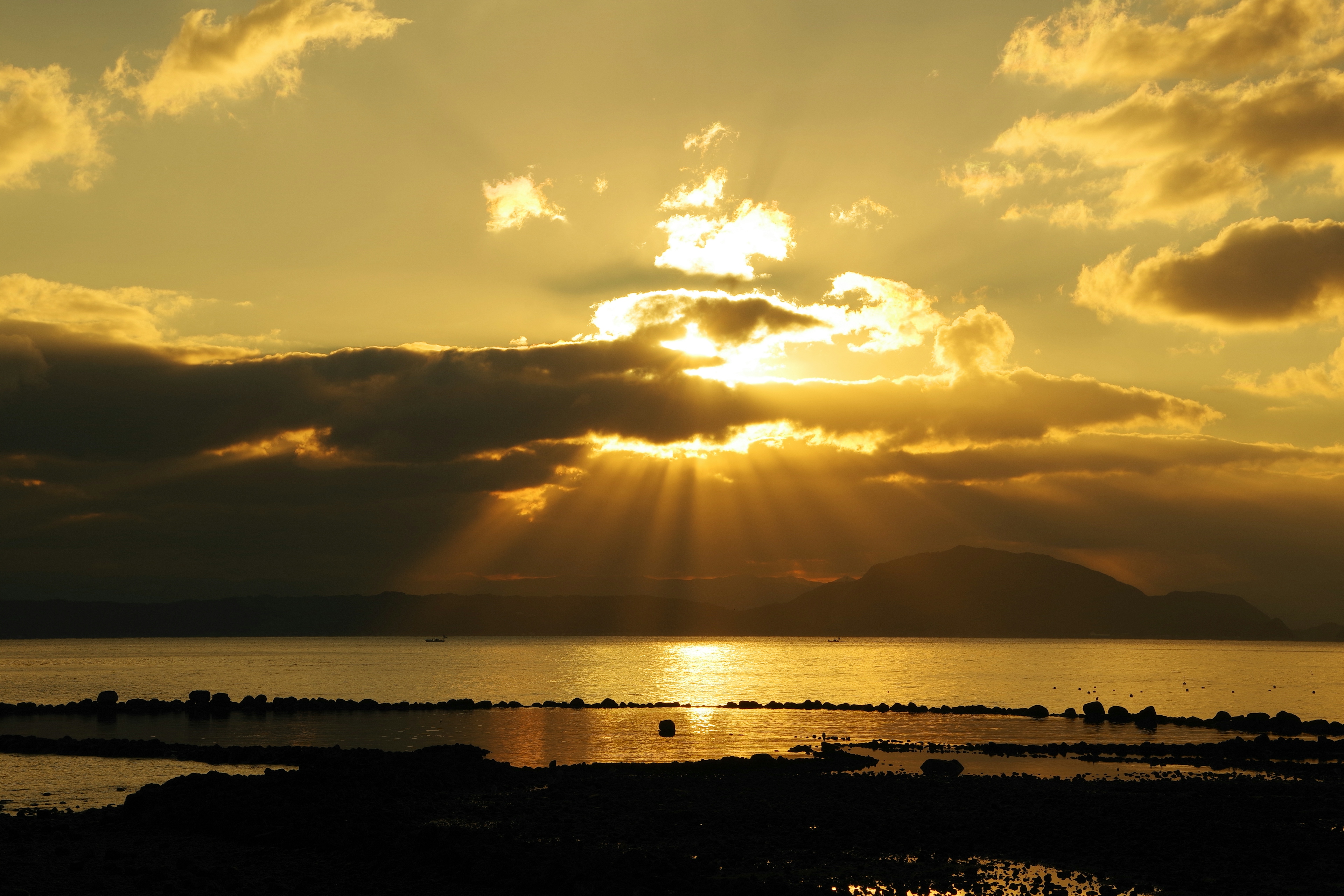 Beautiful landscape with sunset rays shining through clouds