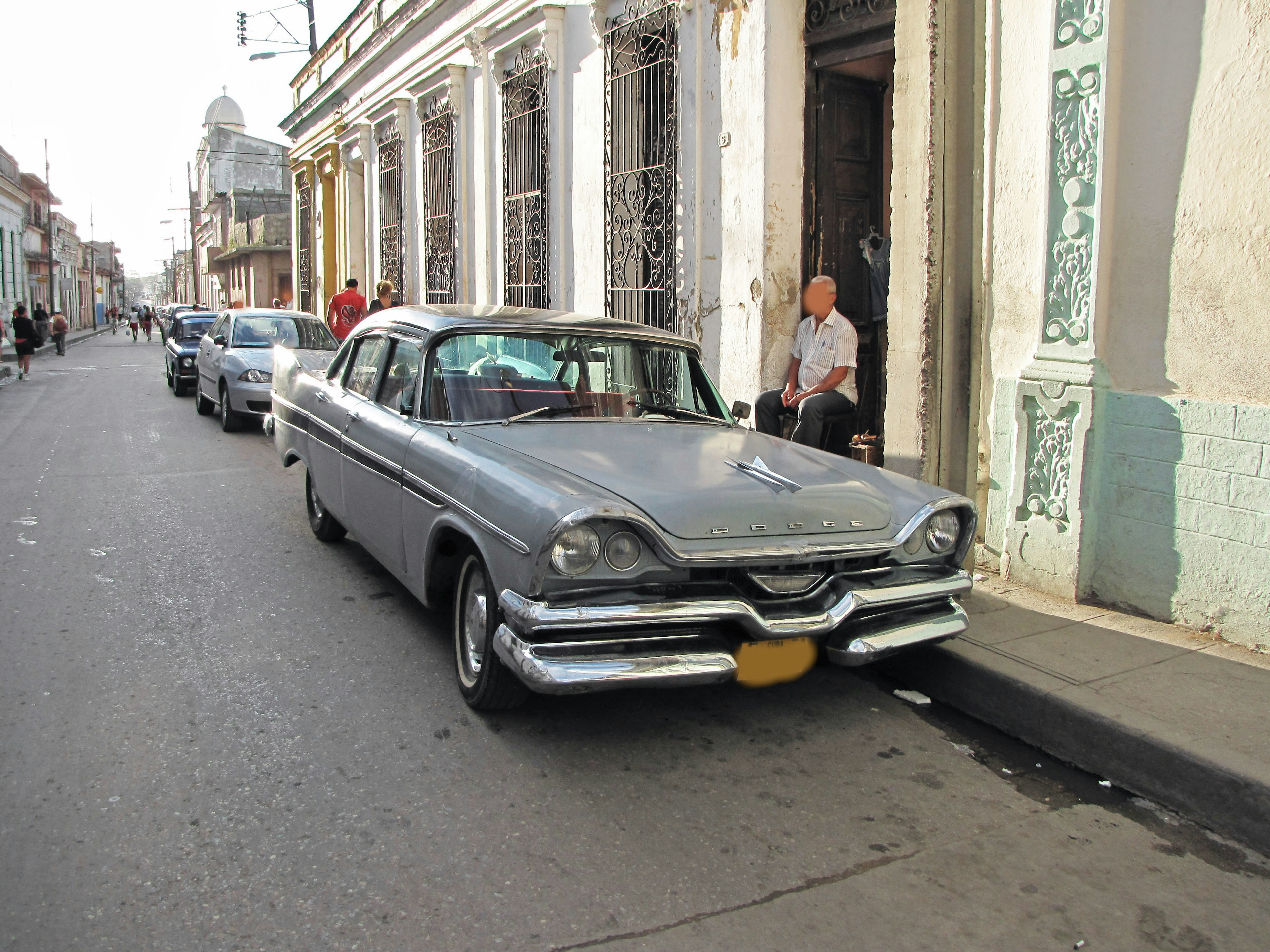 Vintage silver car parked on a city street