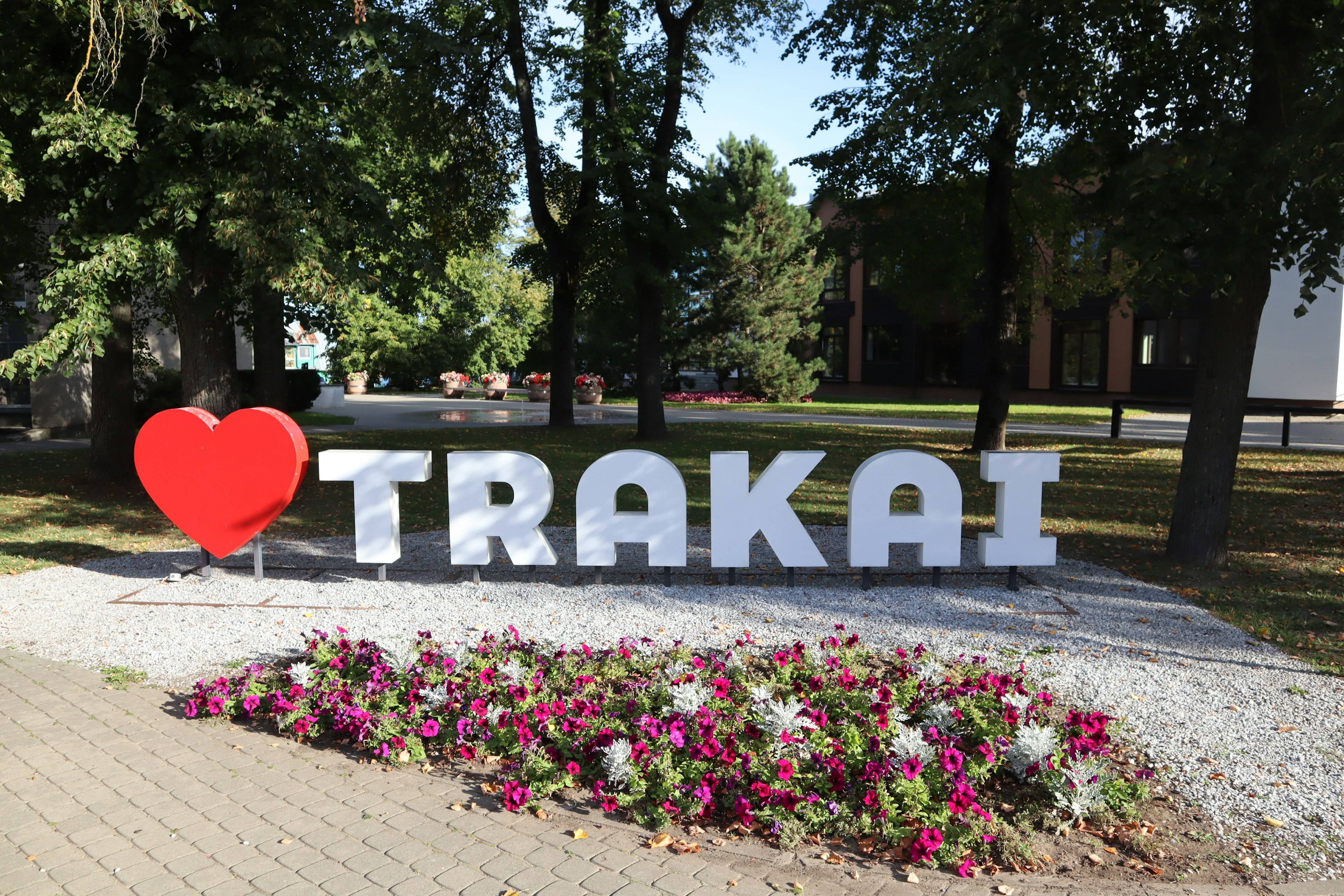 Large sign saying I love TRAKAI with colorful flowers in the foreground