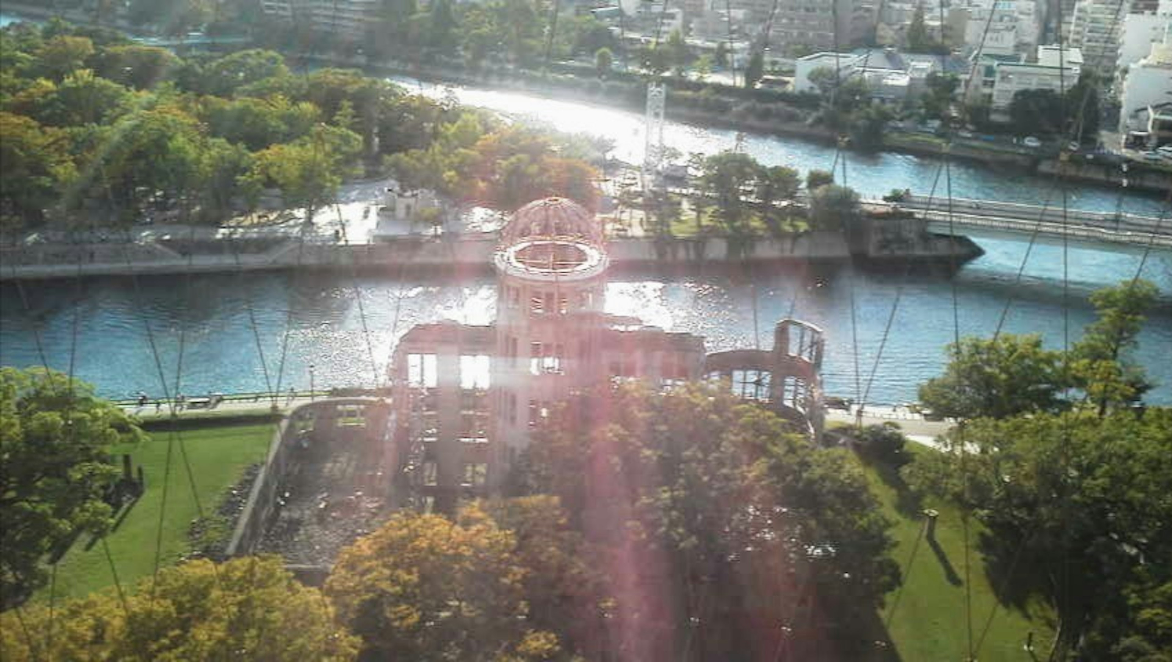 Scenic view of a river and park with sunlight shining