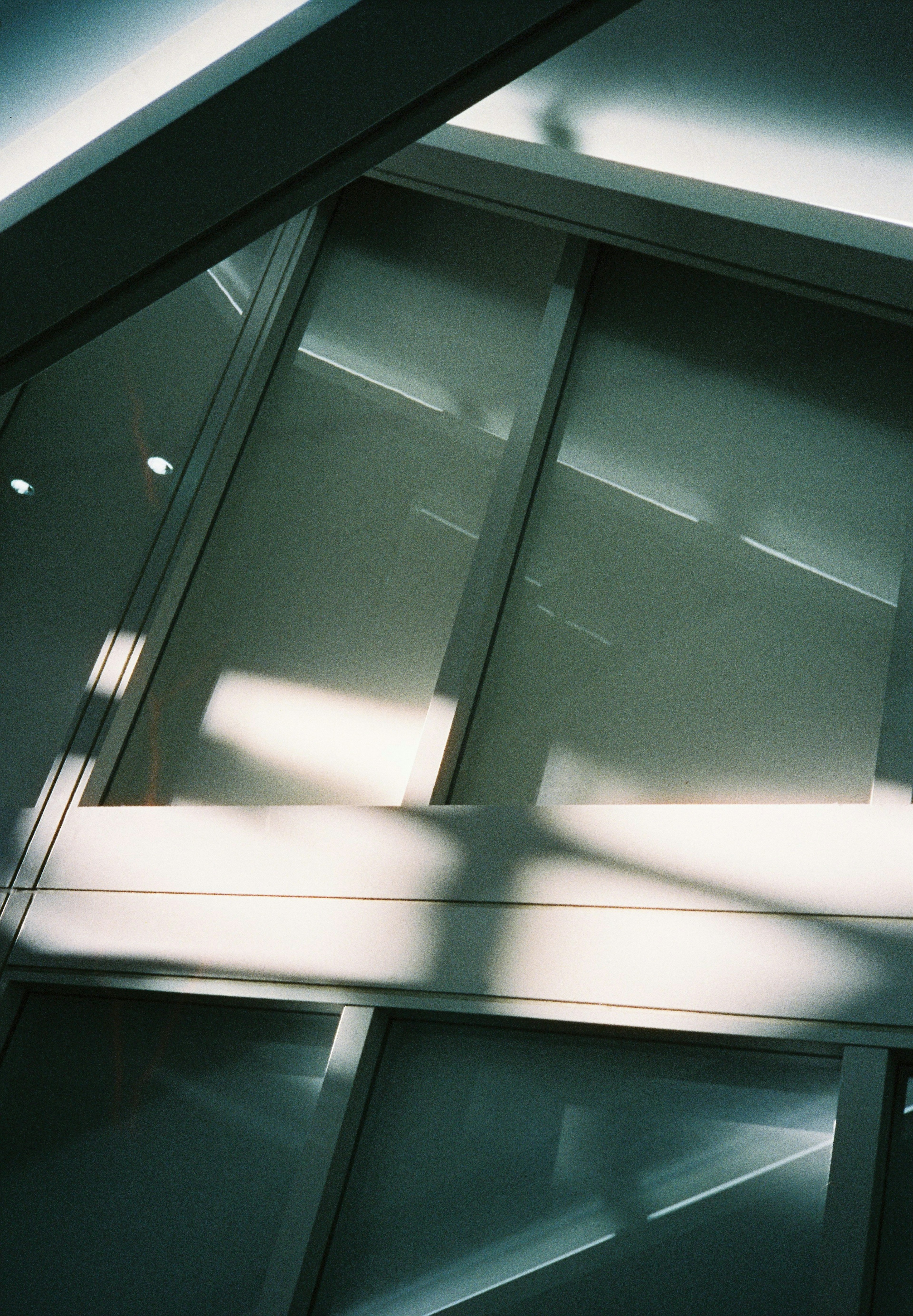 Geometric design of white and green wall with light and shadow