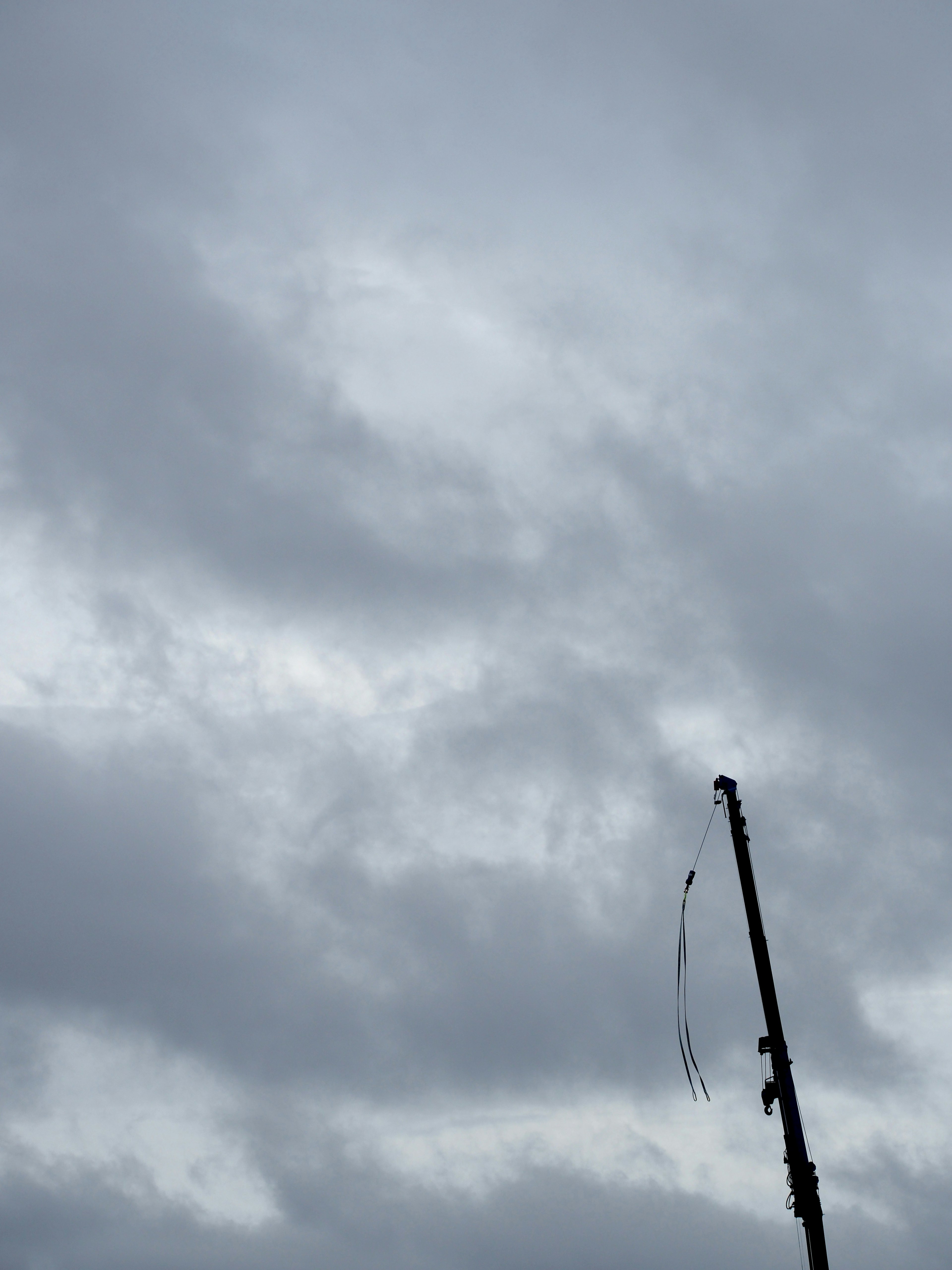 Cloudy sky with a tall utility pole partially visible