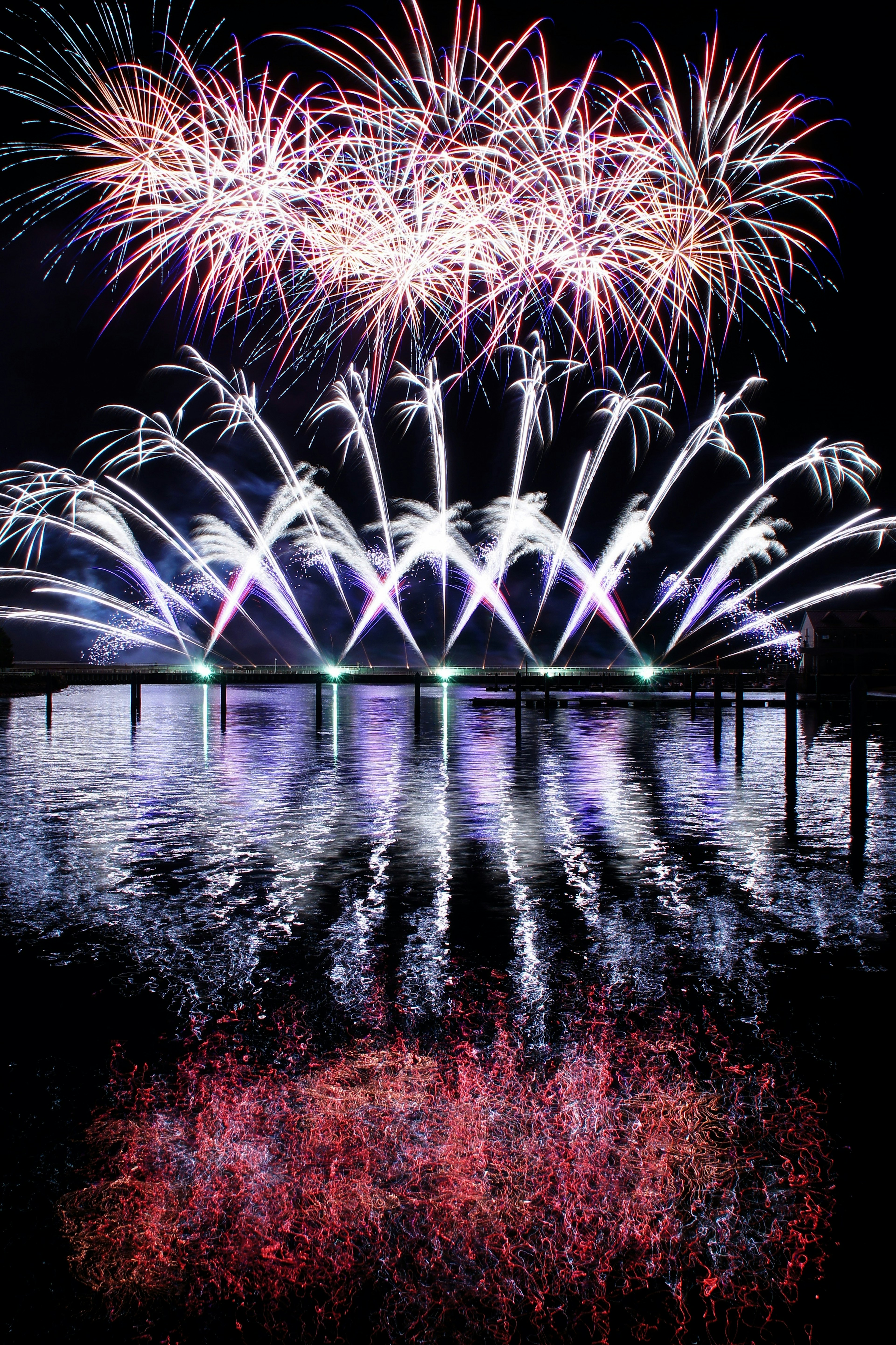 Beautiful fireworks reflecting on the water at night