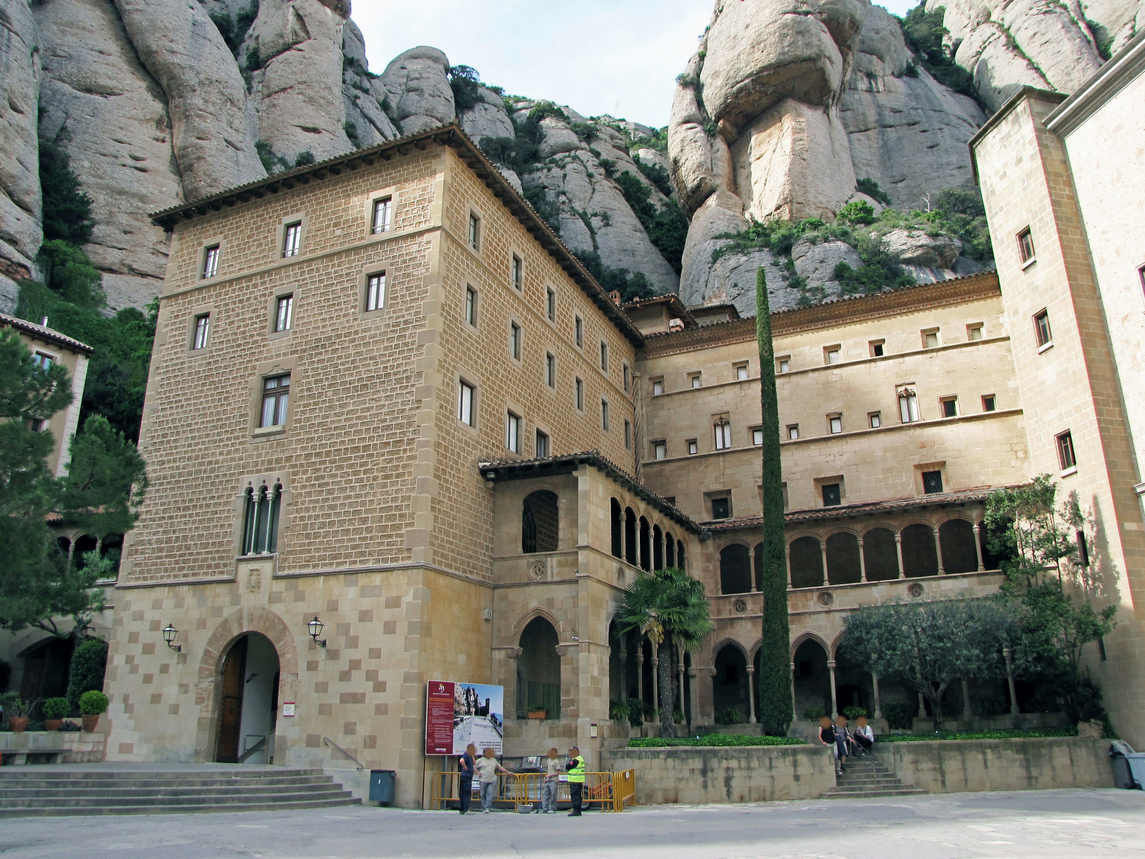 Montserrat Monastery stone building surrounded by greenery and rocky mountains