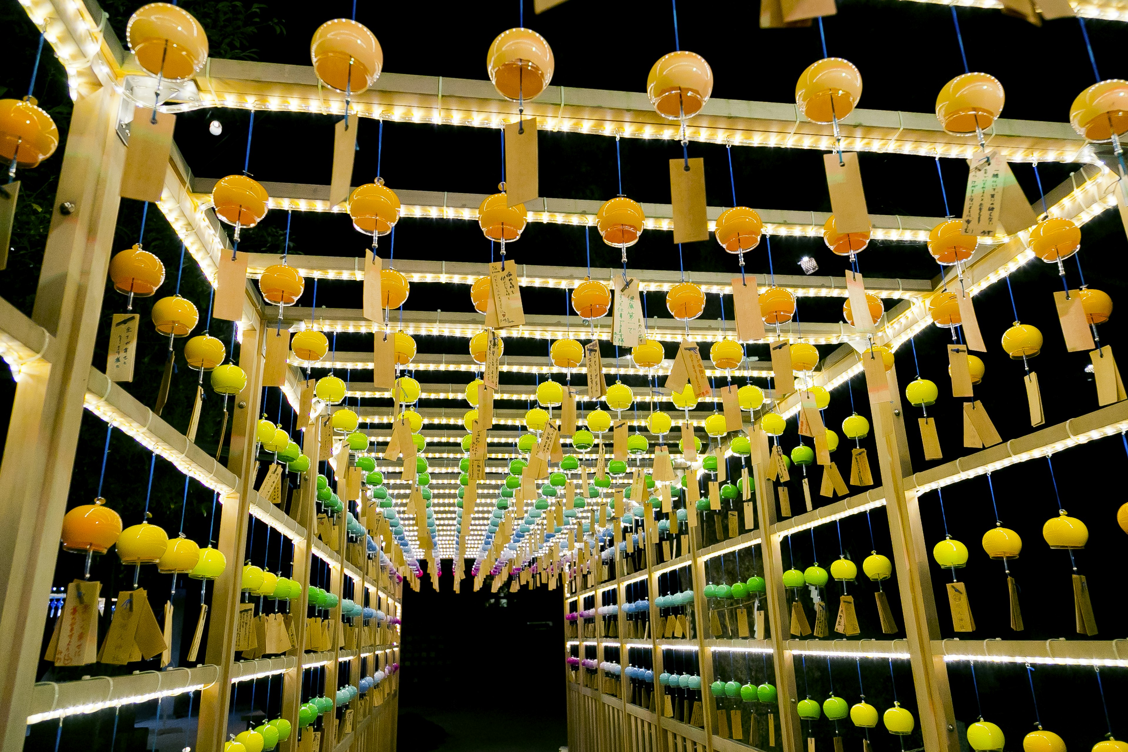 A tunnel illuminated at night with colorful lanterns hanging