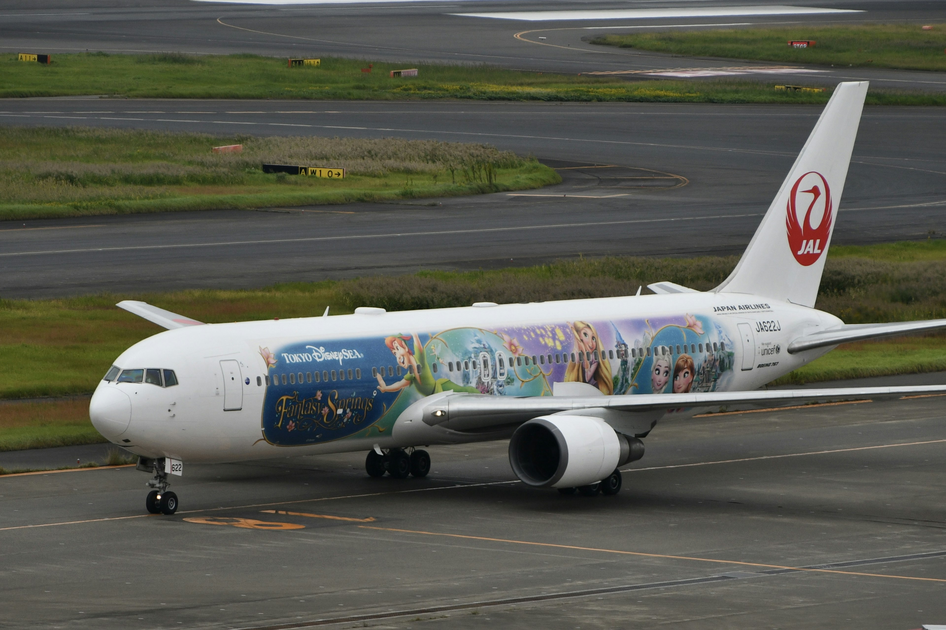 Japan Airlines special livery aircraft taxiing on the runway