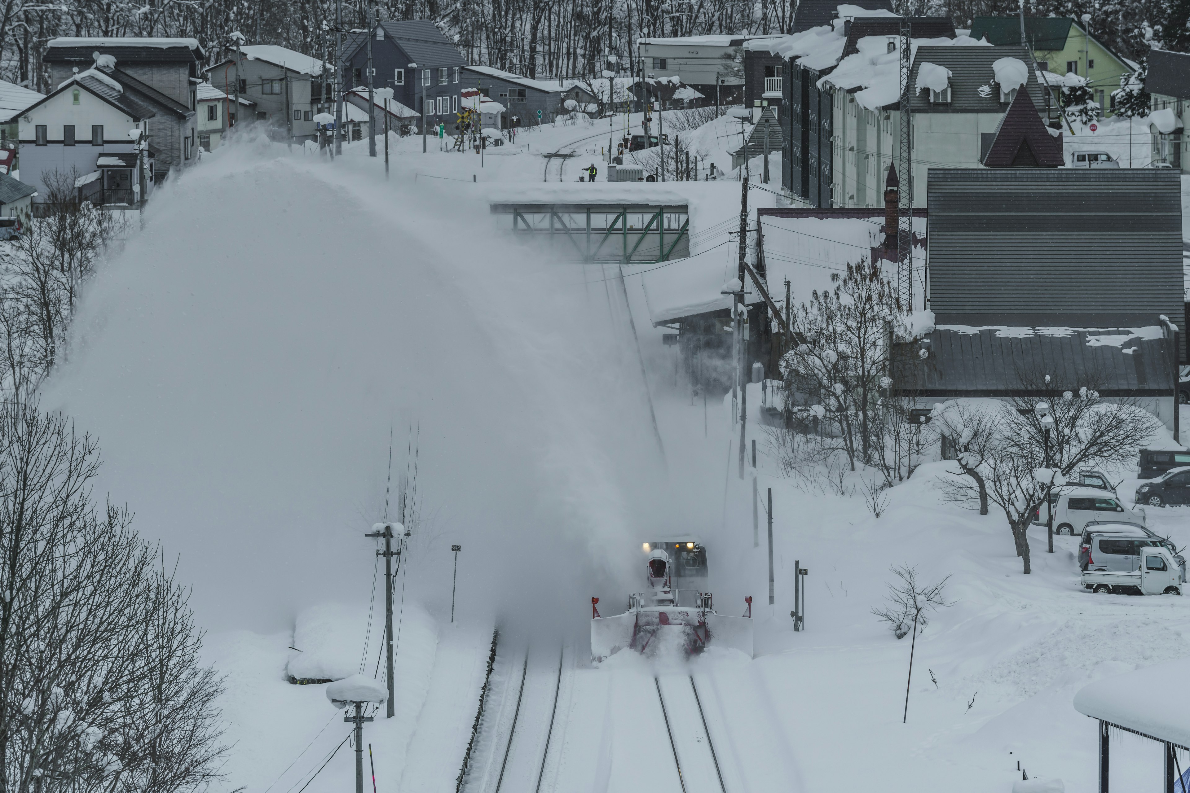 Train clearing snow in a winter landscape