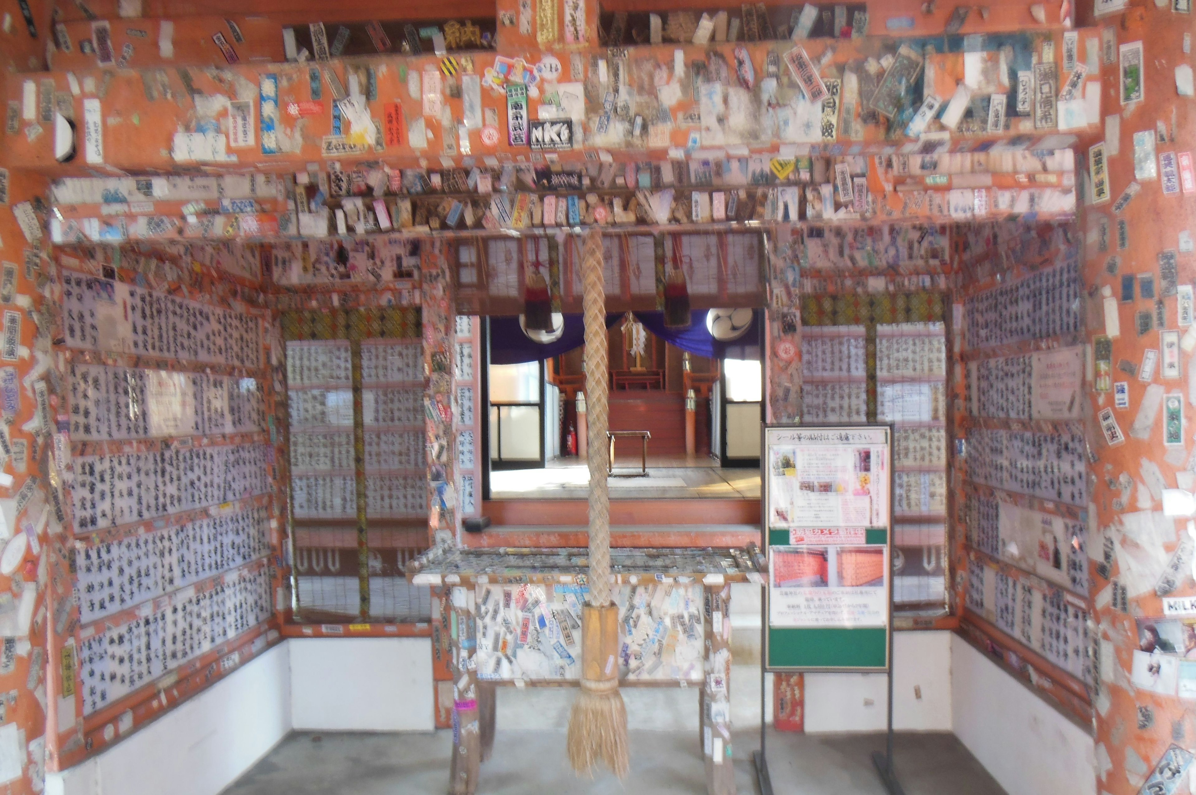 Interior view with red walls covered in various images and messages