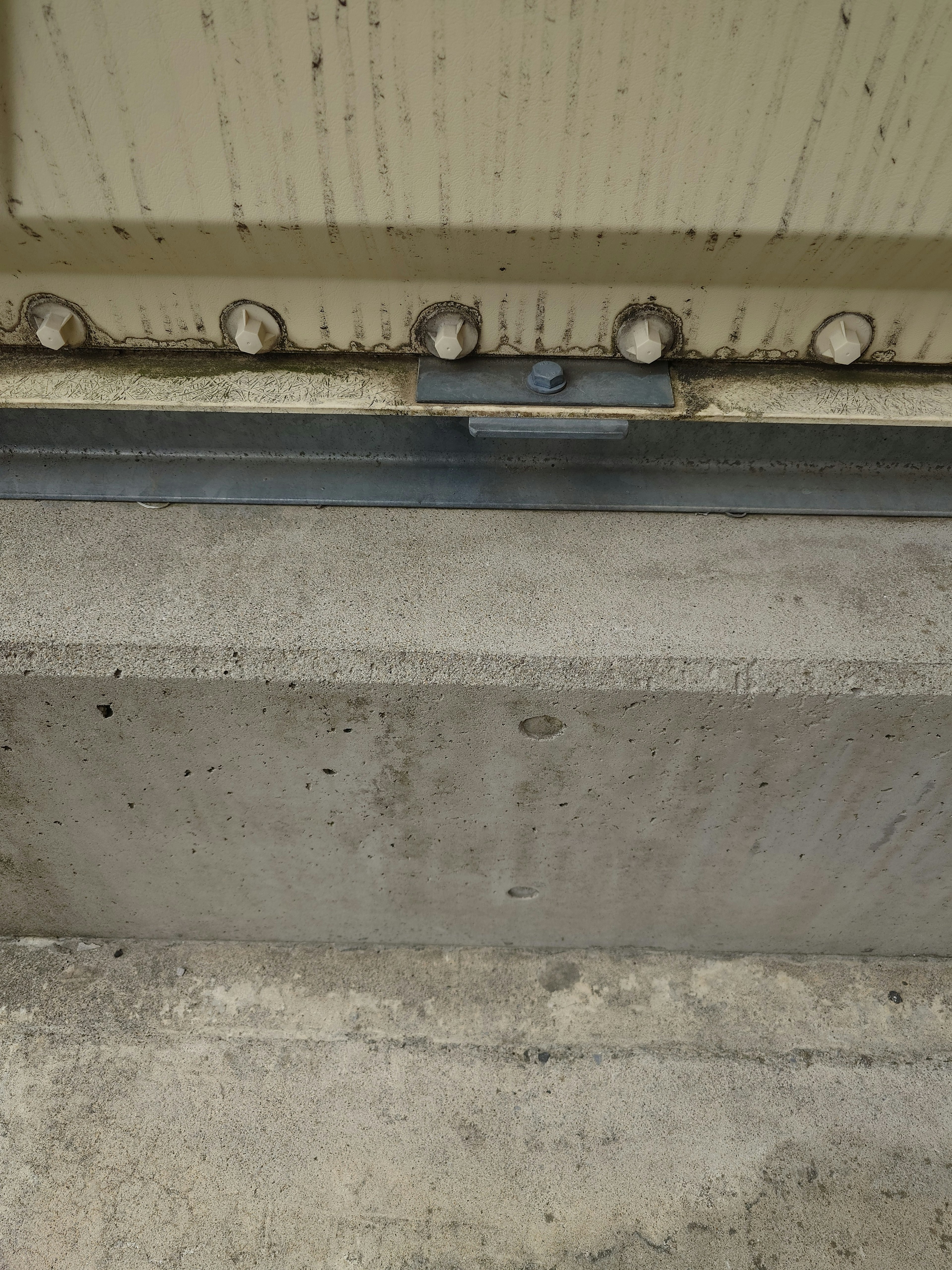 Image showing the bottom of a metal door and concrete floor