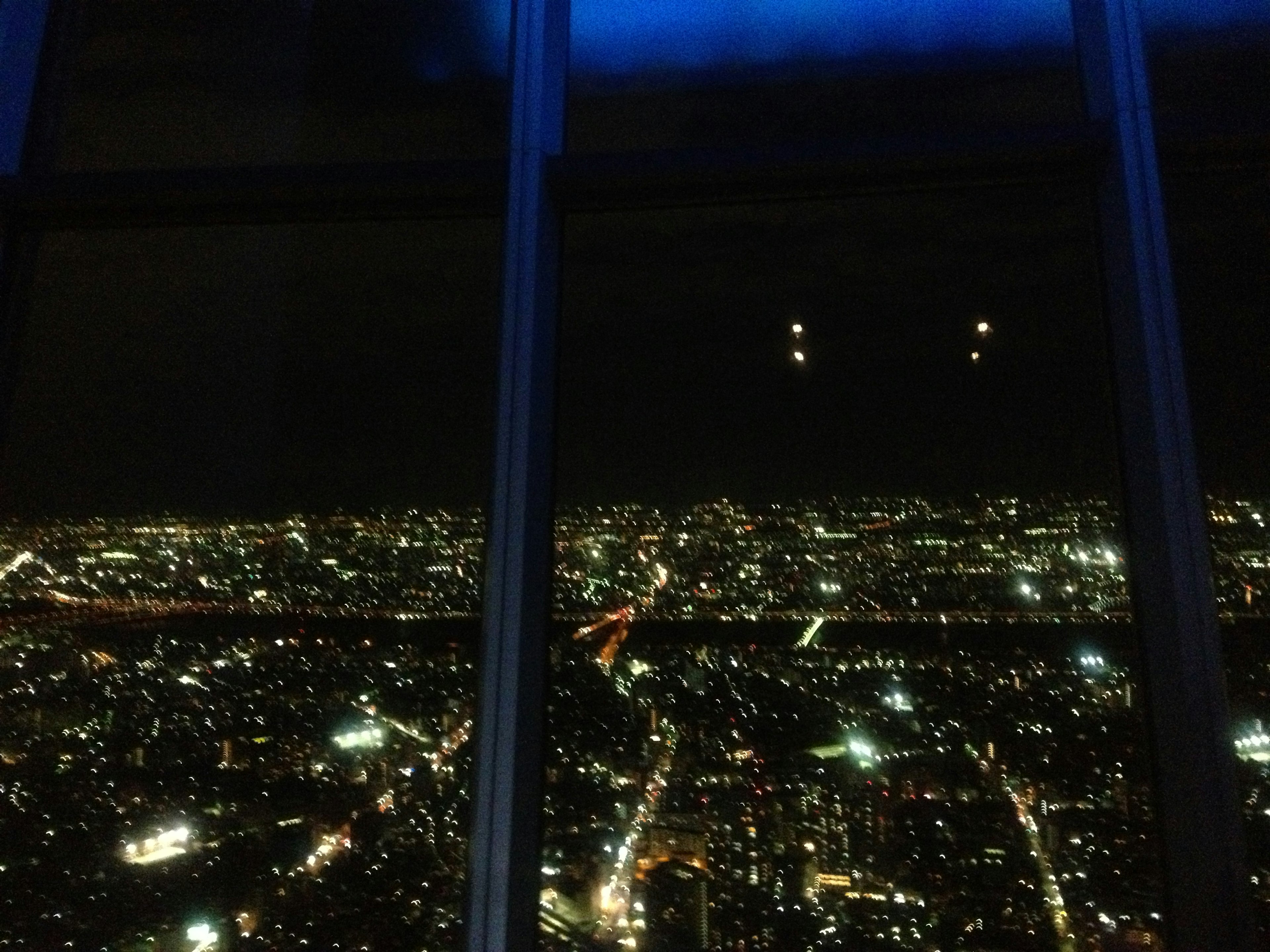 Panoramic view of city skyline at night with sparkling lights