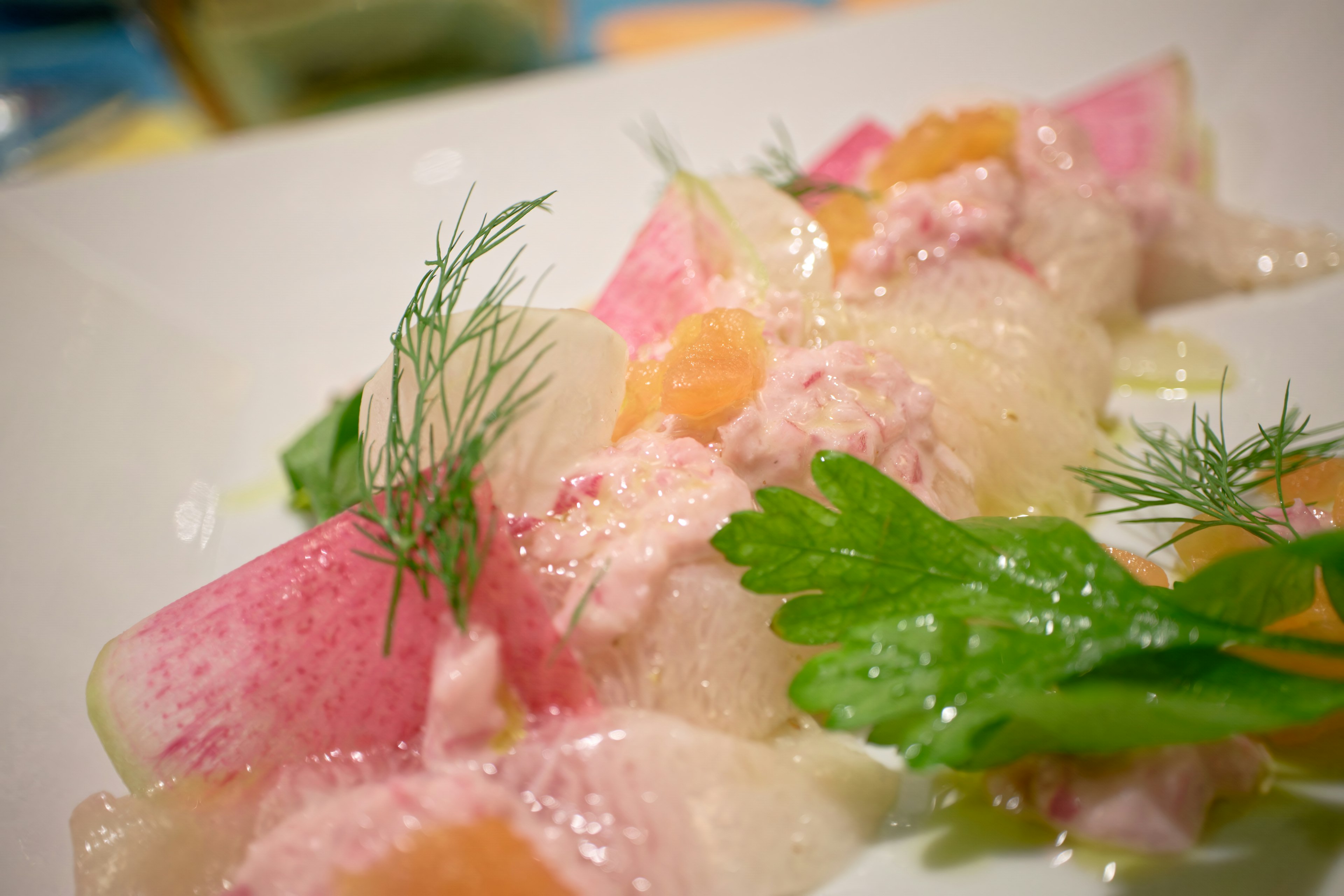 A beautifully presented salad featuring colorful vegetables and fresh herbs