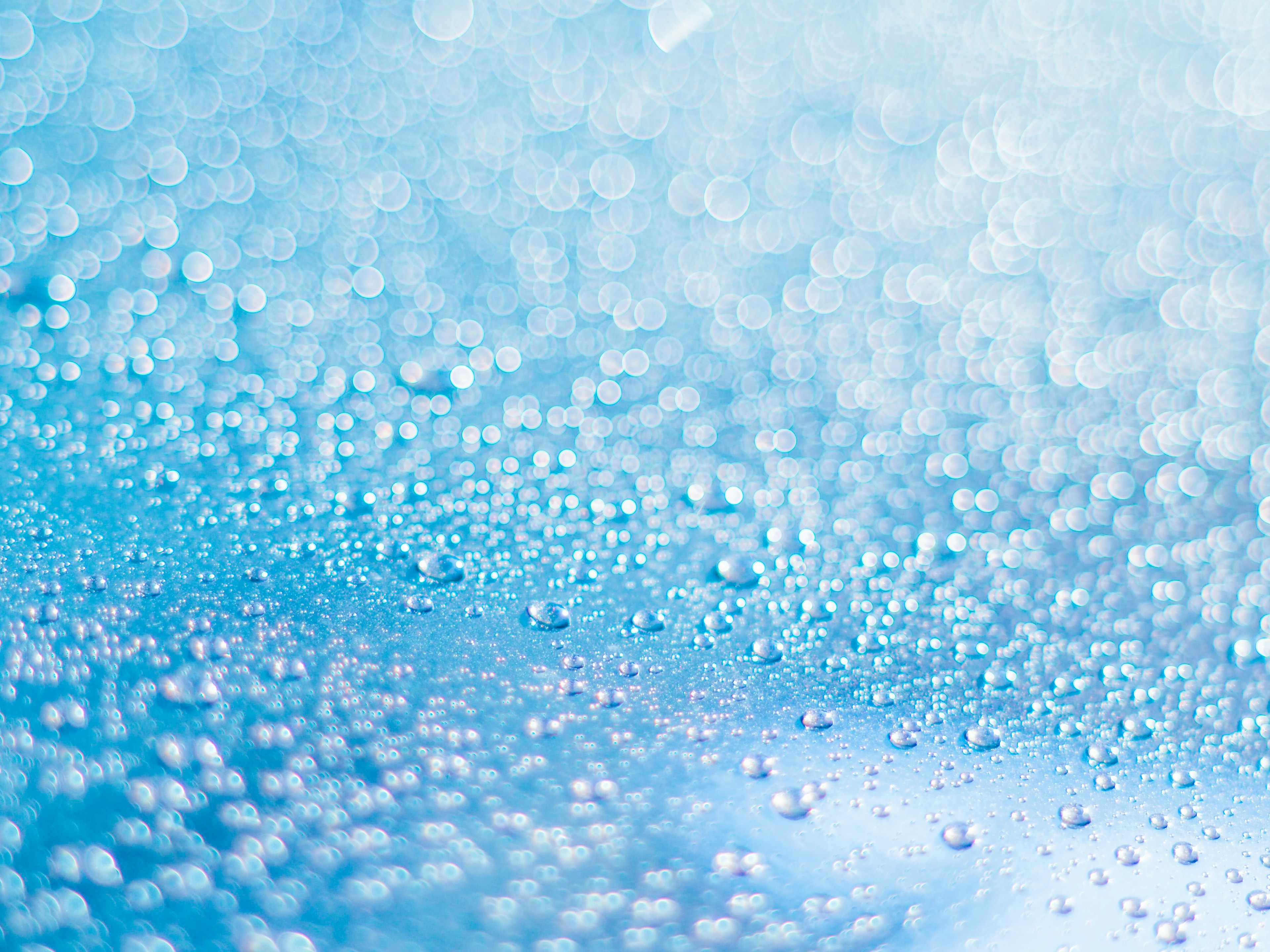 Vibrant image of water droplets scattered on a blue background