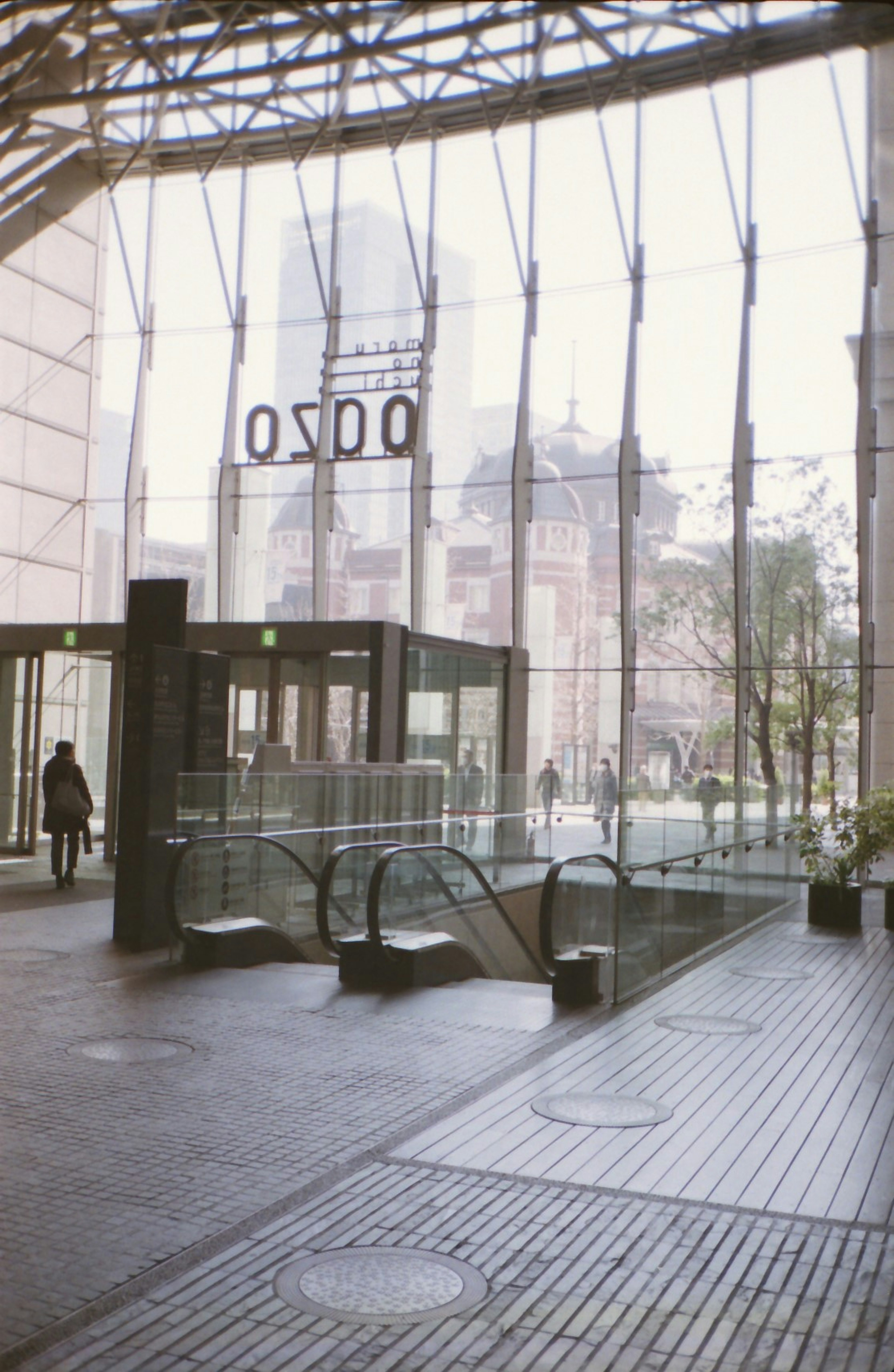 Interior de un edificio moderno con grandes ventanas de vidrio que muestran una vista exterior