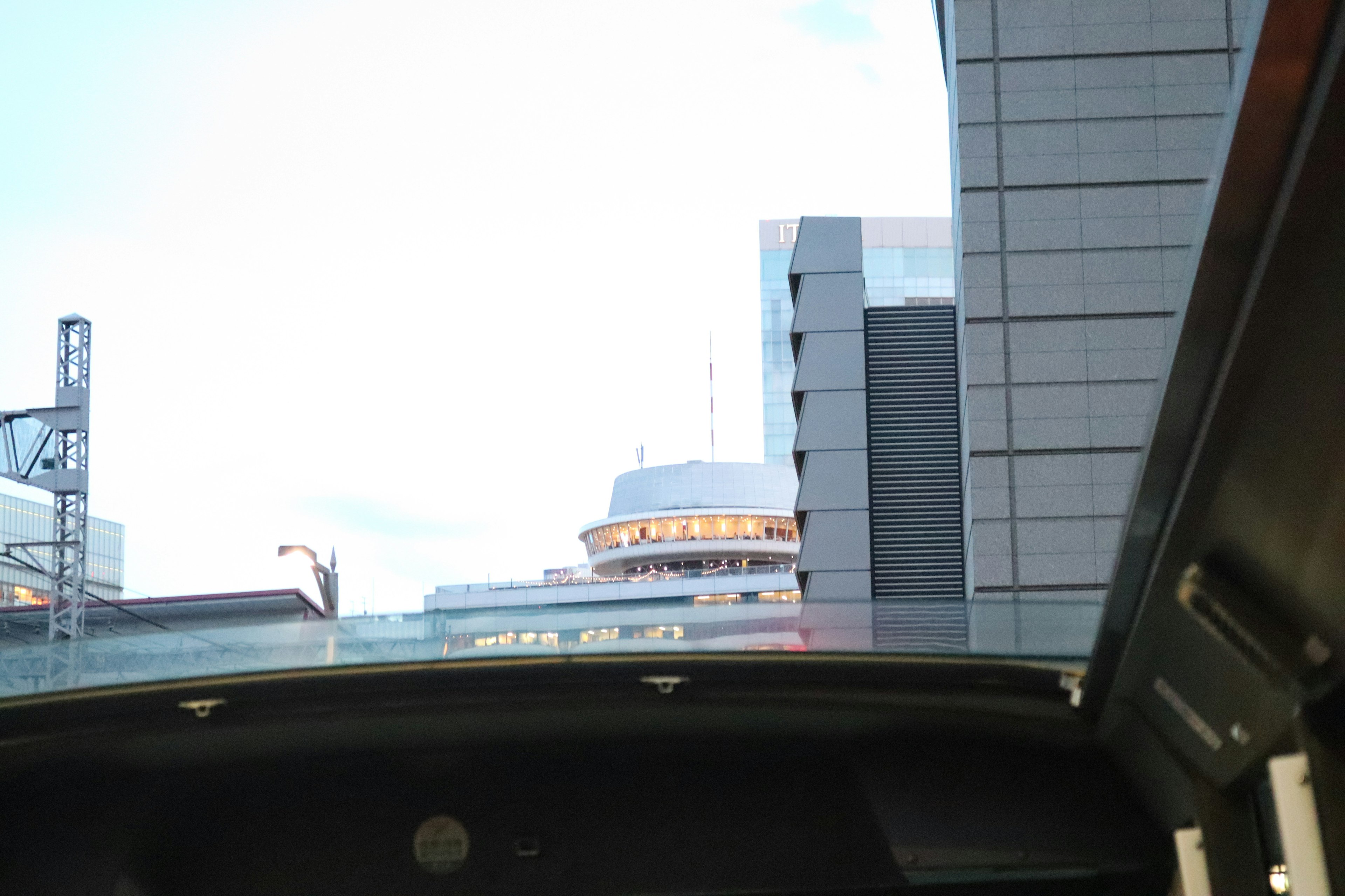 View of the city from an open-top vehicle featuring skyscrapers and a clear sky