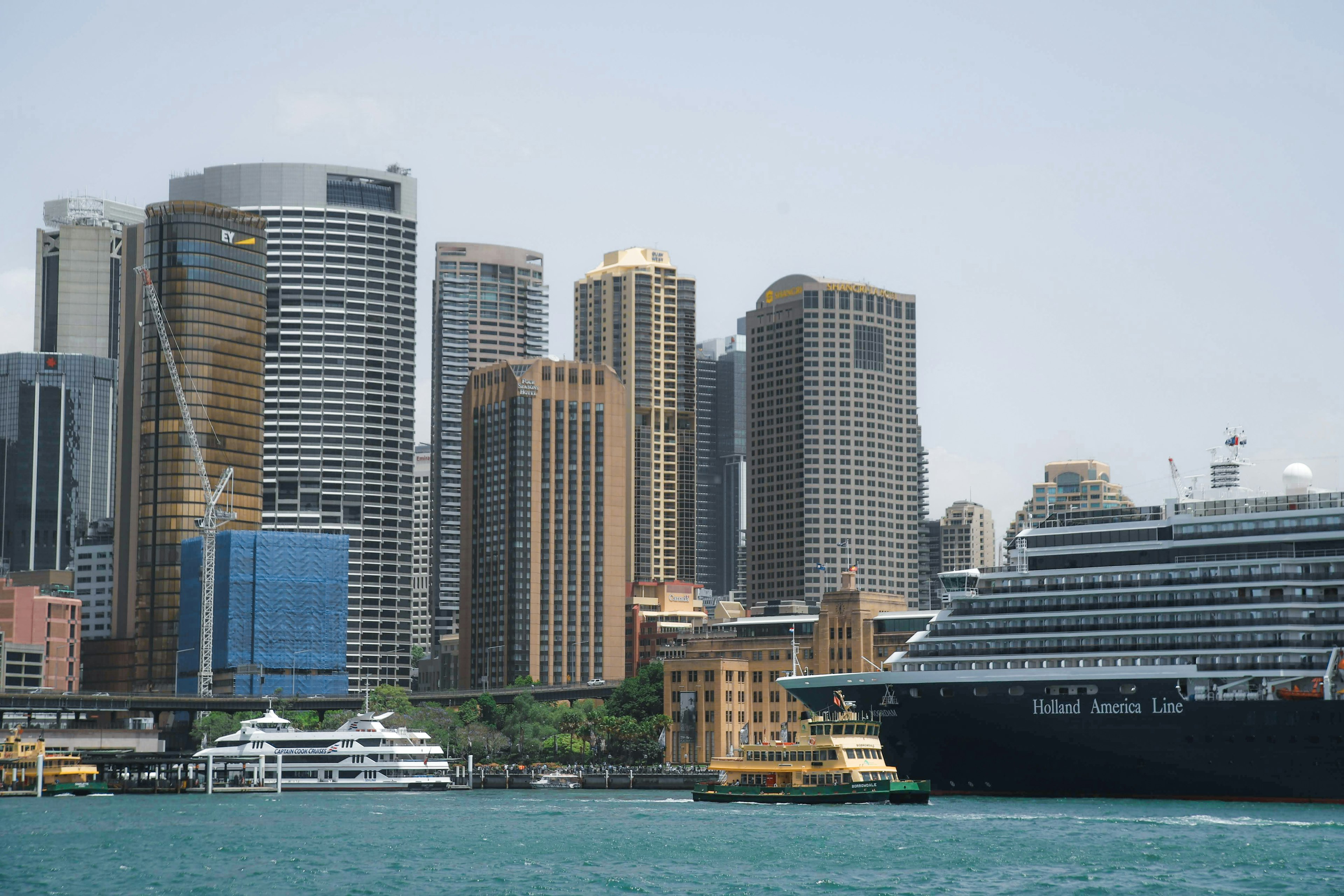 Sydney skyline with skyscrapers and a docked cruise ship