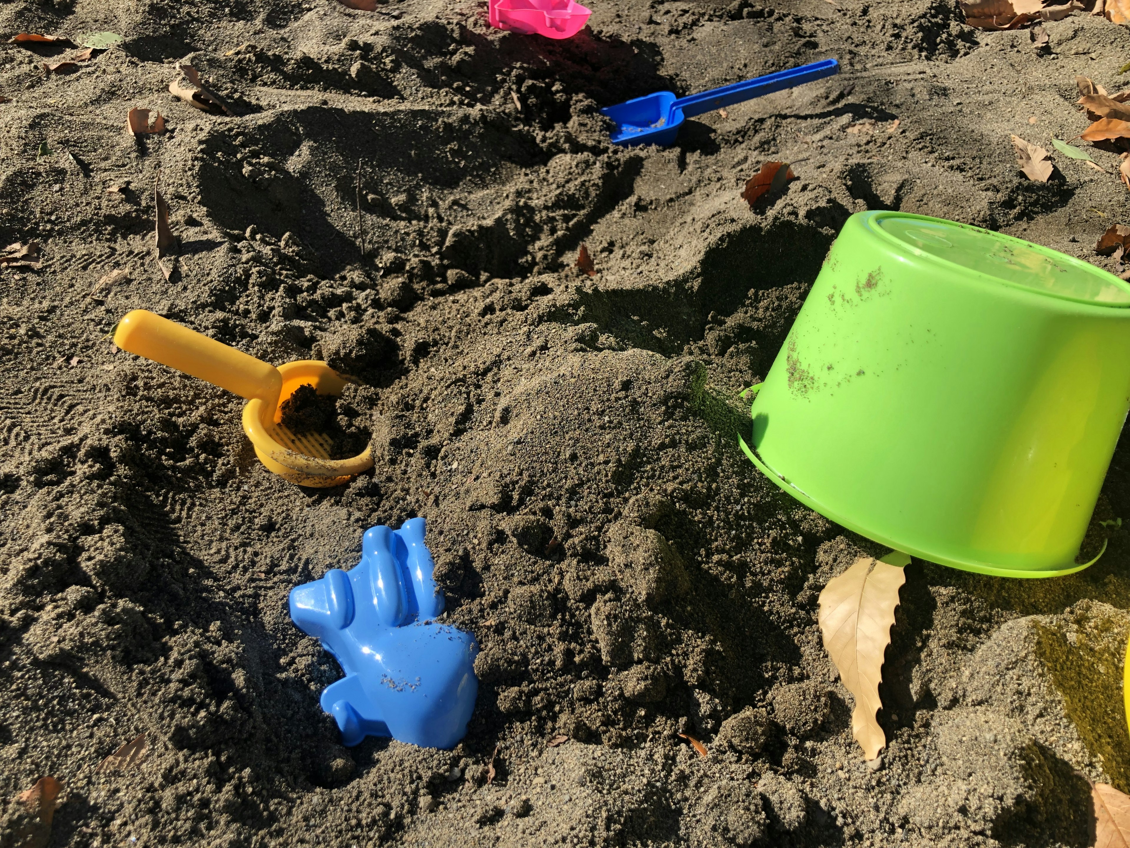 Colorful sand play toys buried in a sandbox