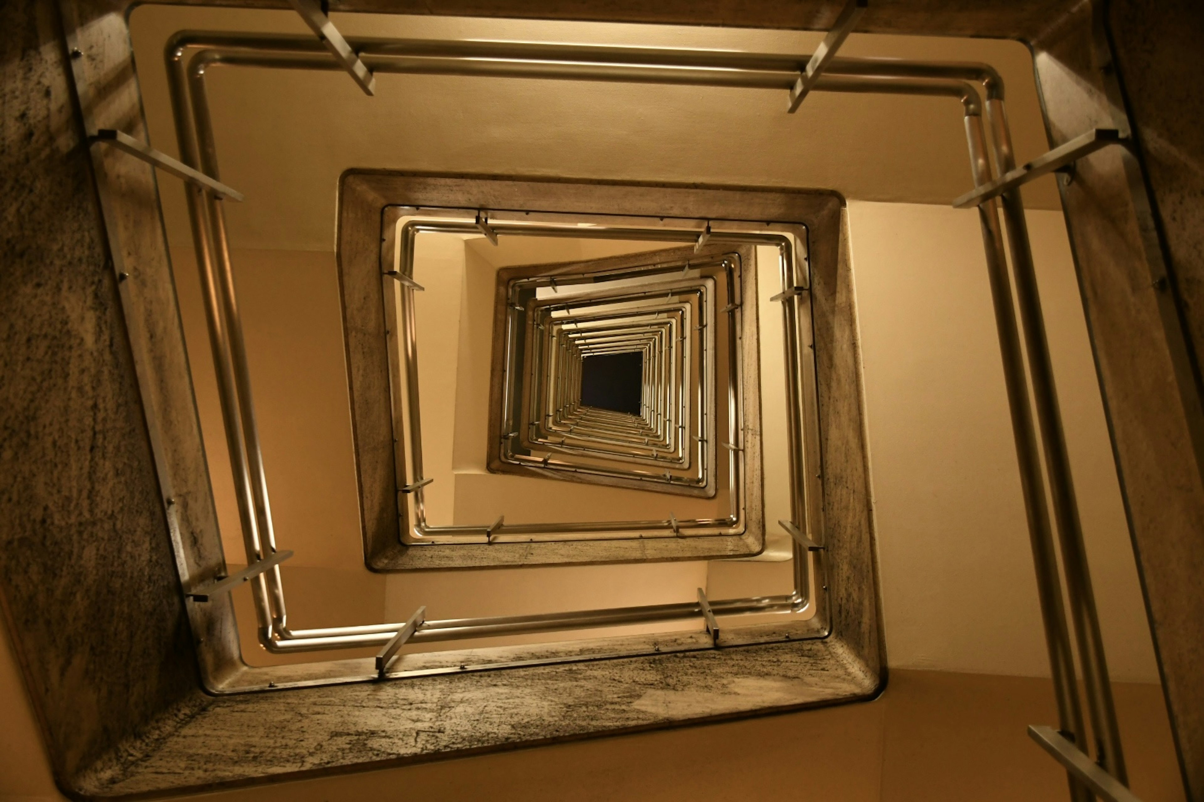 View looking up from the bottom of a spiral staircase